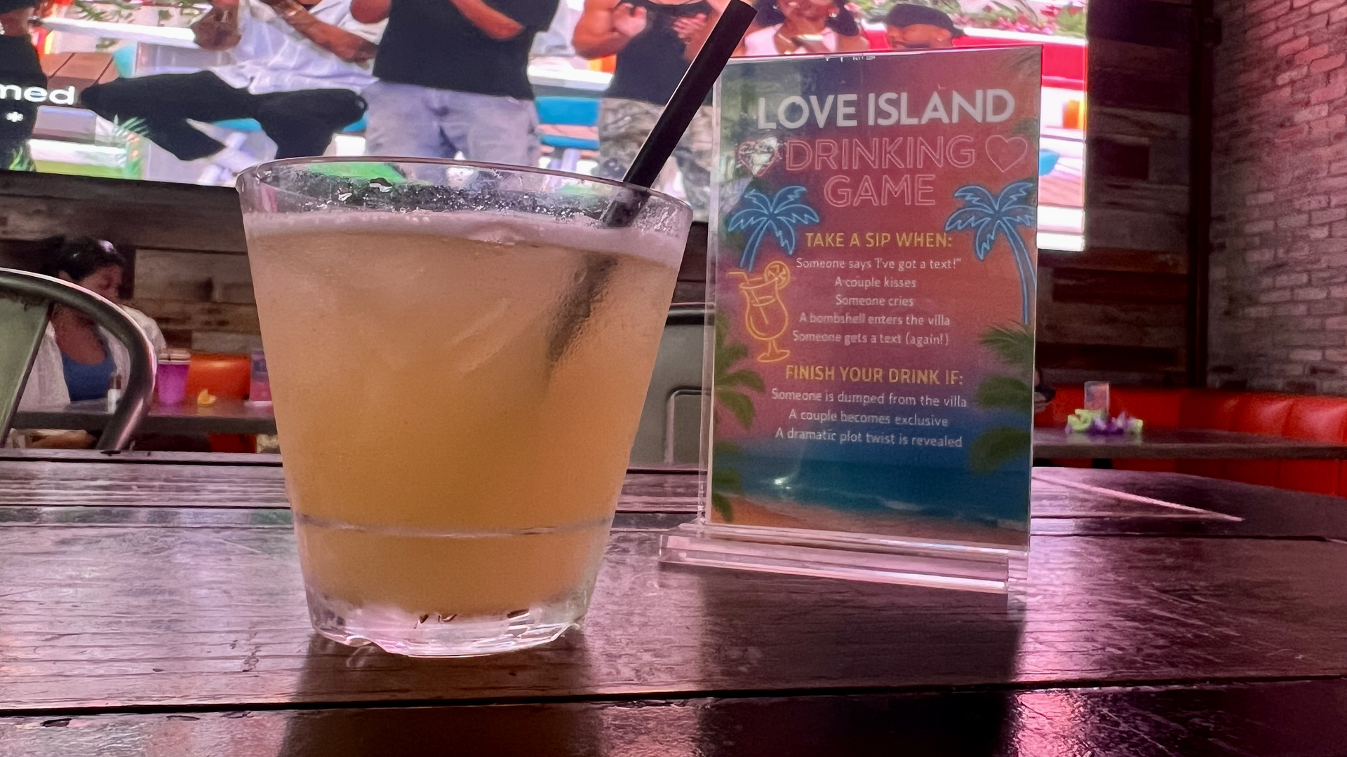 A clear glass with a yellow drink