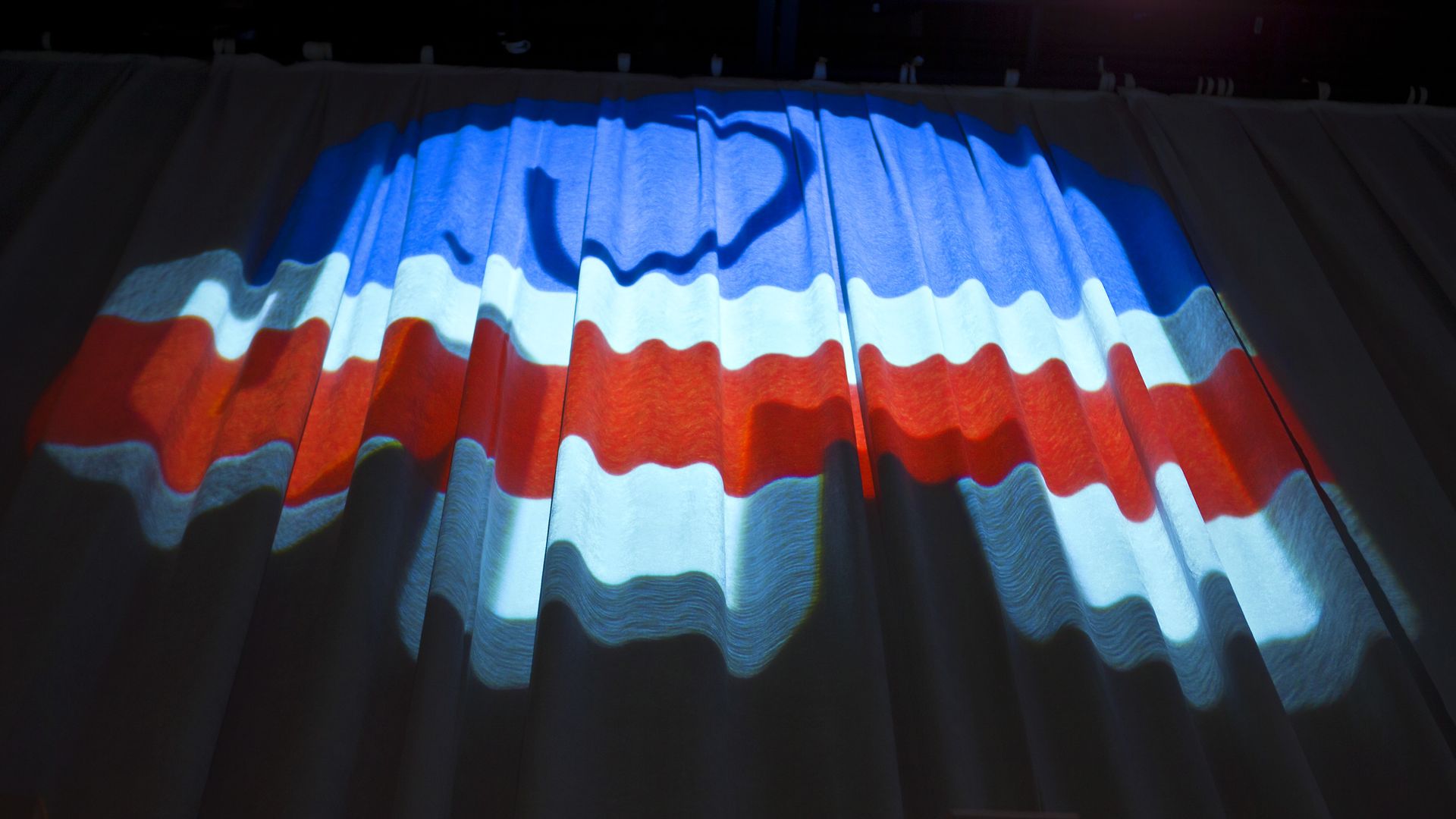 Lights reflected on a curtain reveal the shape of the GOP elephant