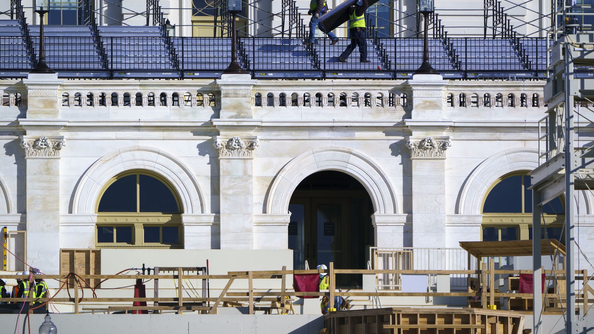 With Inauguration Day two months away on Jan. 20, 2021, construction crews work on the platforms where the president-elect will take the oath of office, at the Capitol in Washington