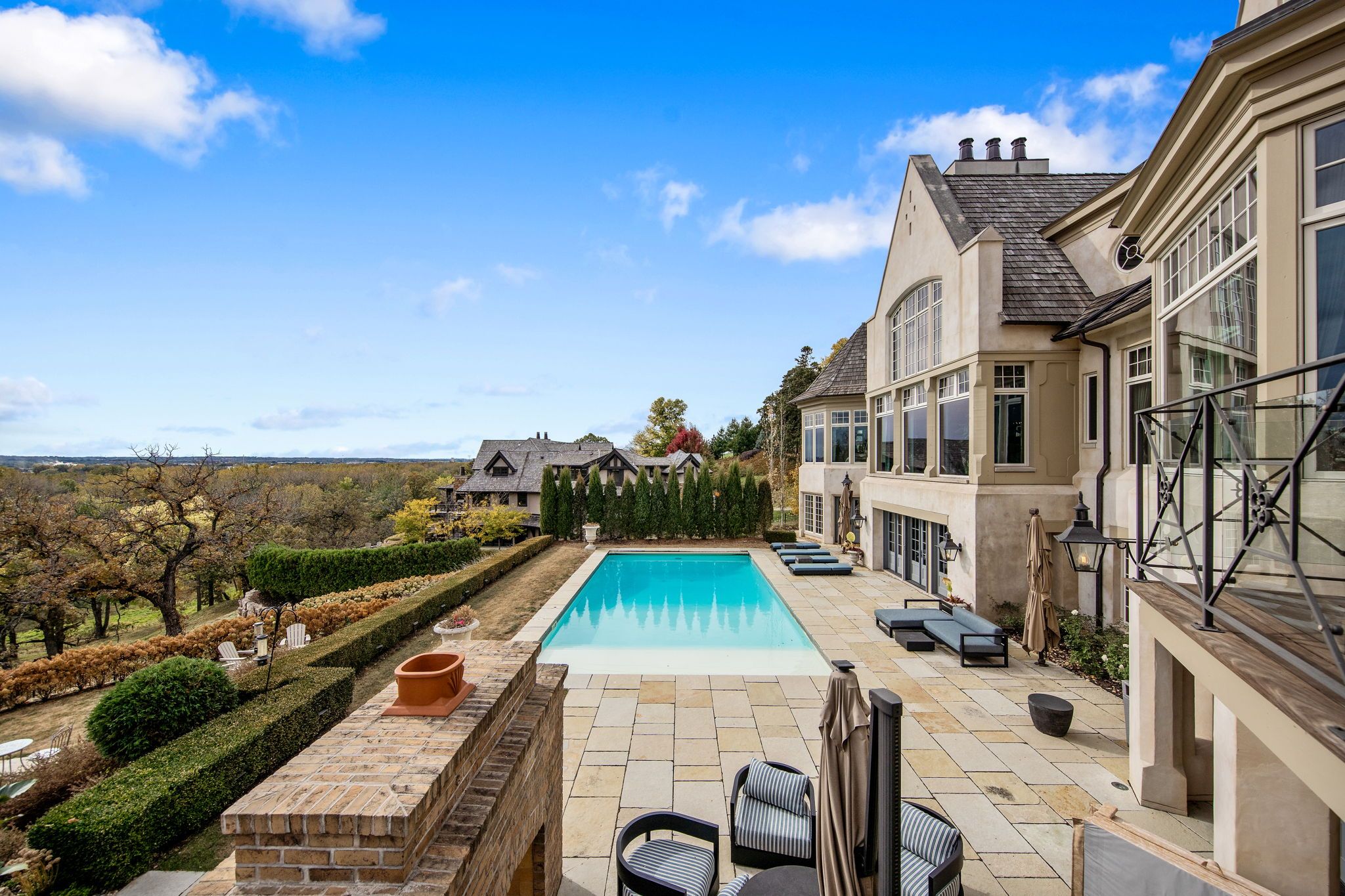 A white mansion with a swimming pool.
