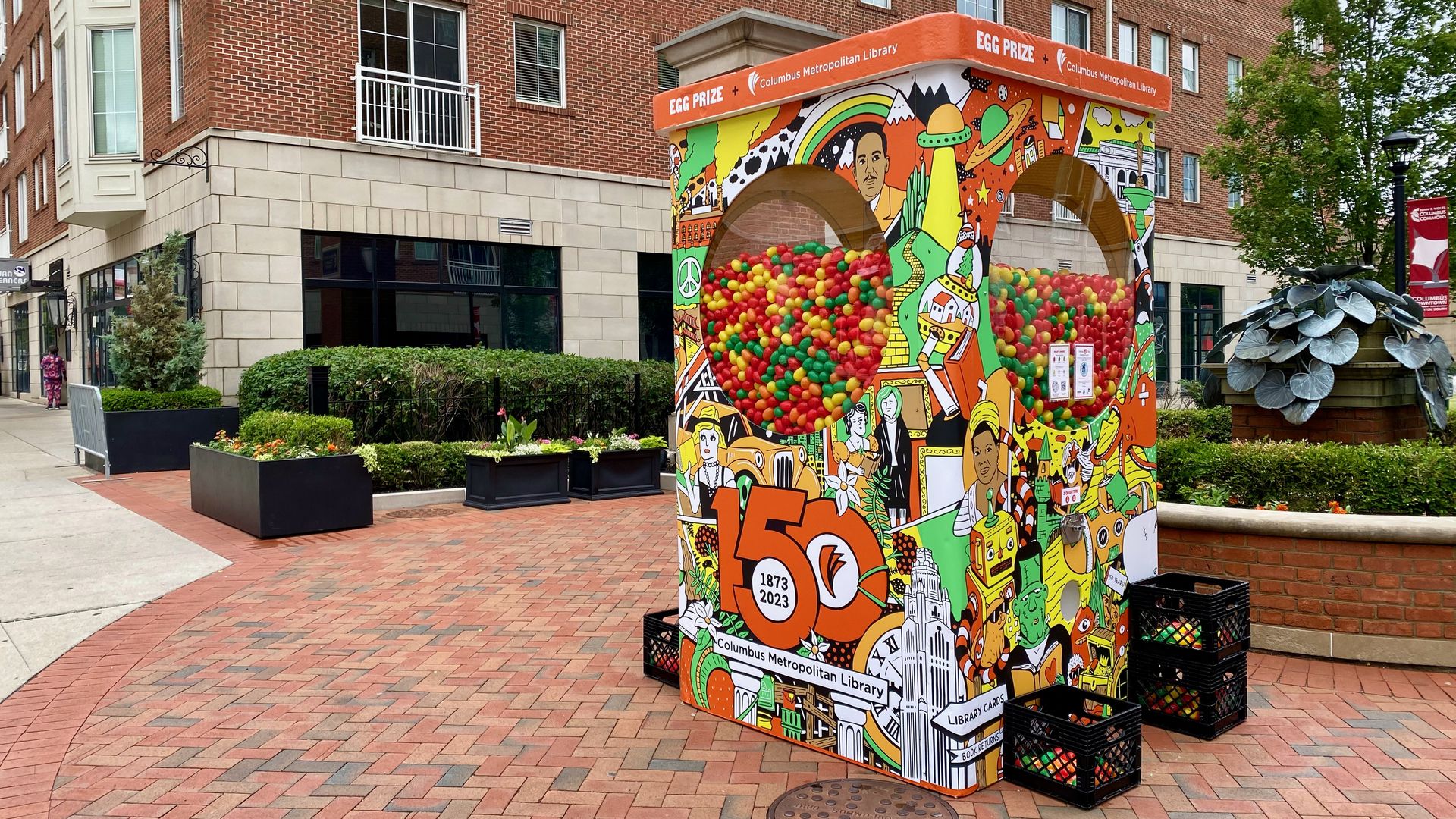 A red, yellow, orange and green-themed vending machine full of plastic eggs