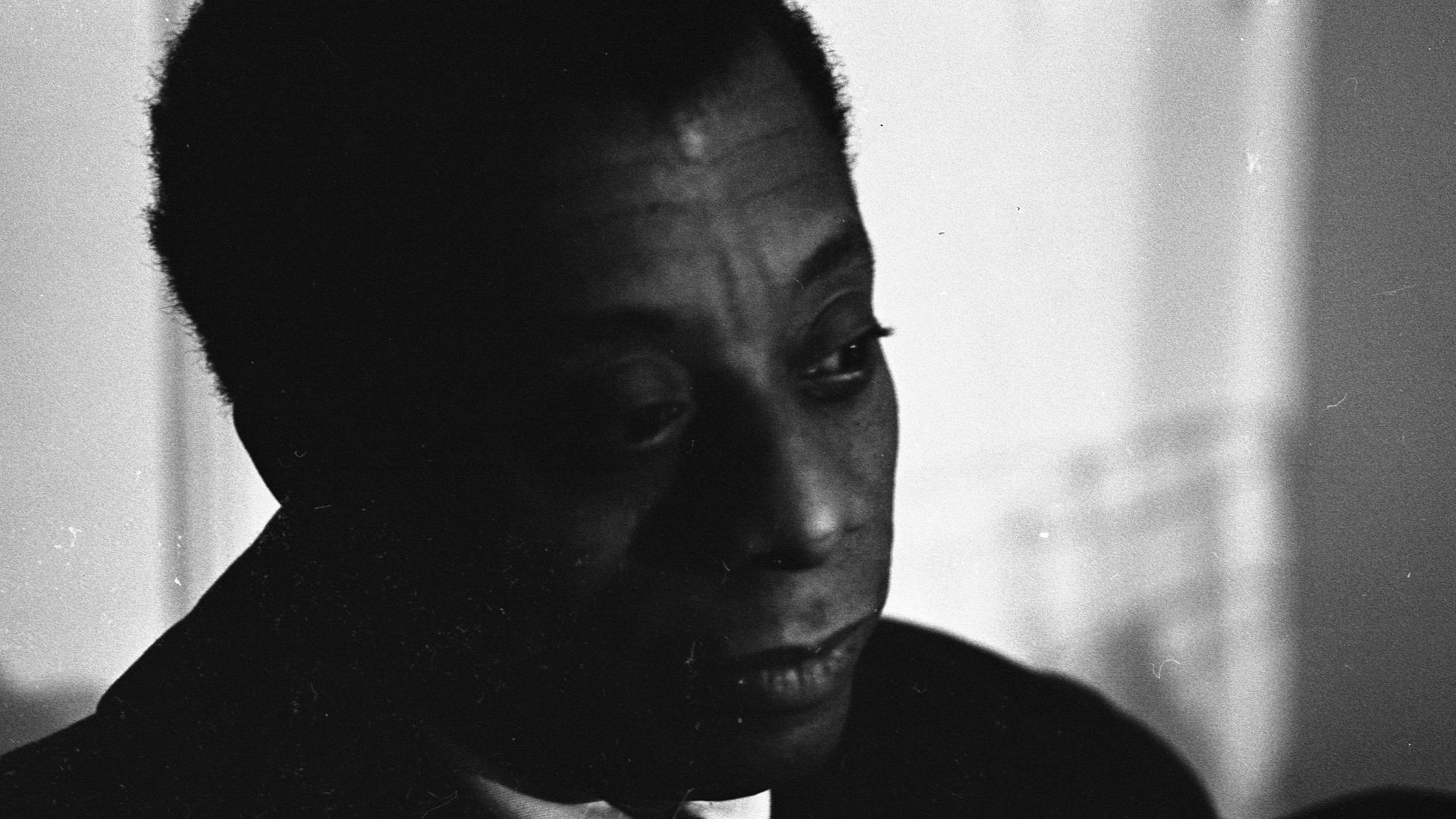 Close-up of American author and playwright James Baldwin (1924 - 1987) as he sits backstage at the ANTA (American National Theater and Academy) Playhouse, New York, New York, April 1964. He was there to attend the opening of his play 'Blues for Mr Charlie.'