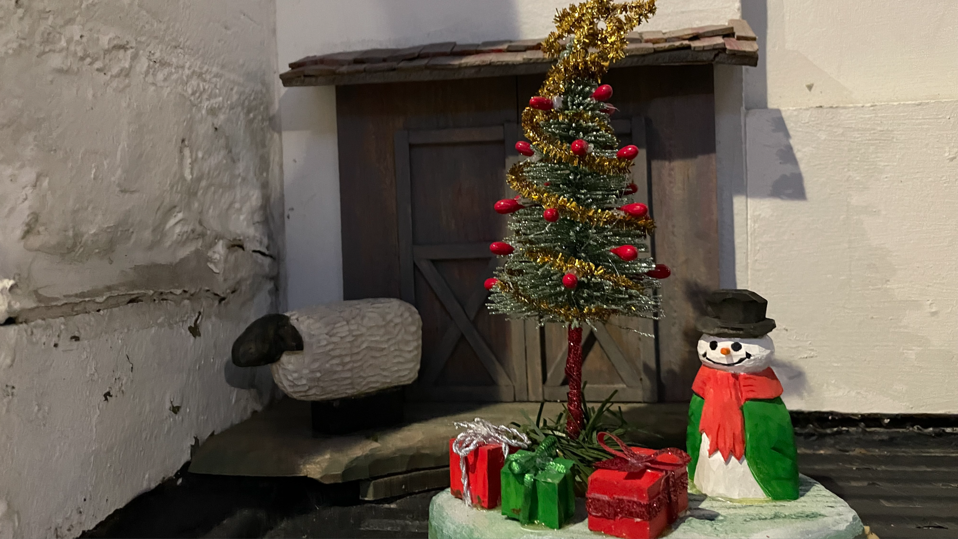 A photo of a tiny door decorated for Christmas