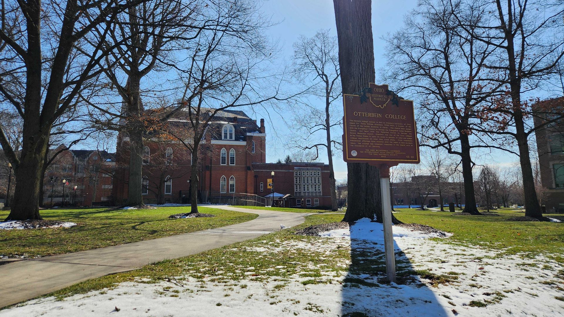 A historical marker on a grassy field on the campus of Otterbein University. 