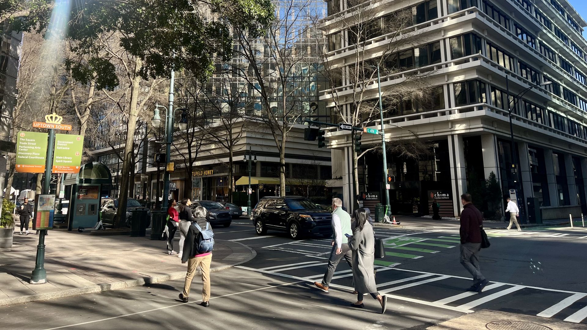 People walking across crosswalk in Uptown Charlotte