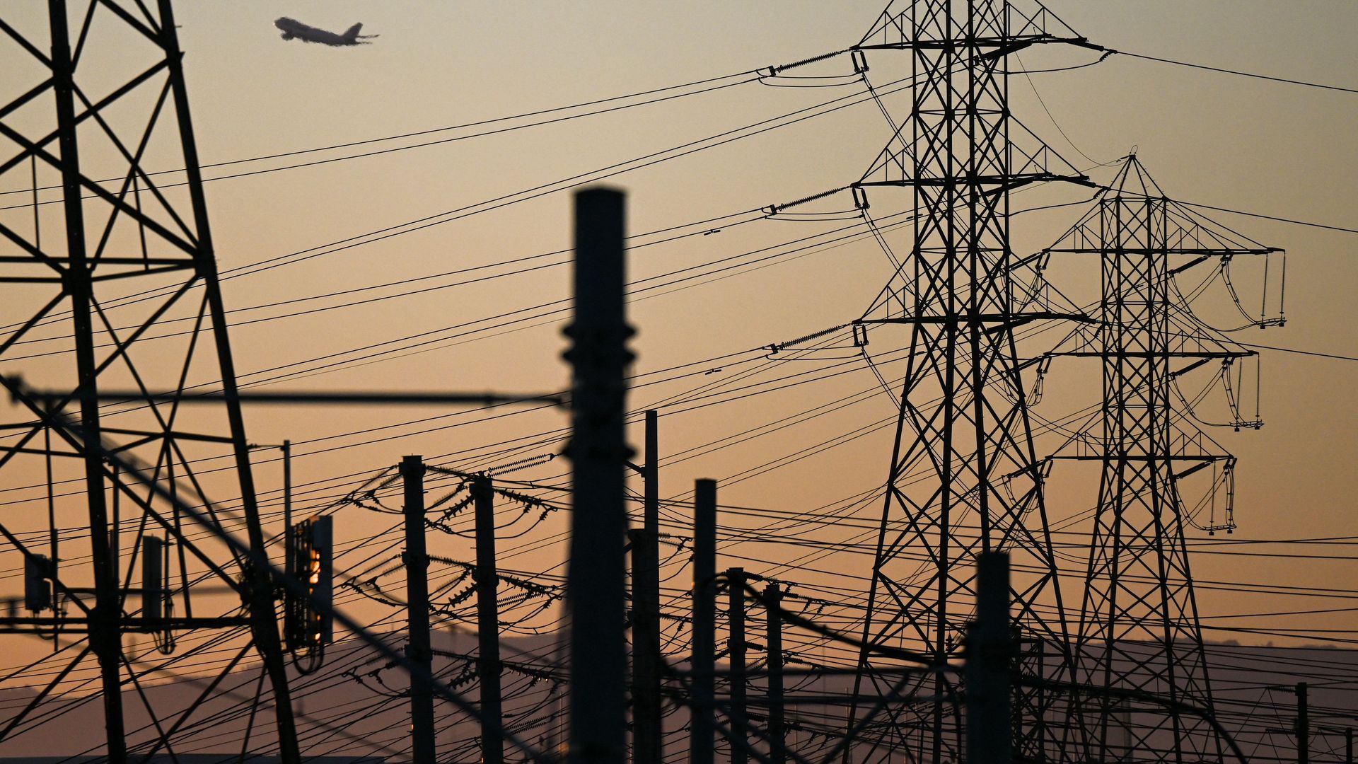 An aircraft takes off from Los Angeles International Airport (LAX) behind electric power lines El Segundo, California on August 31.