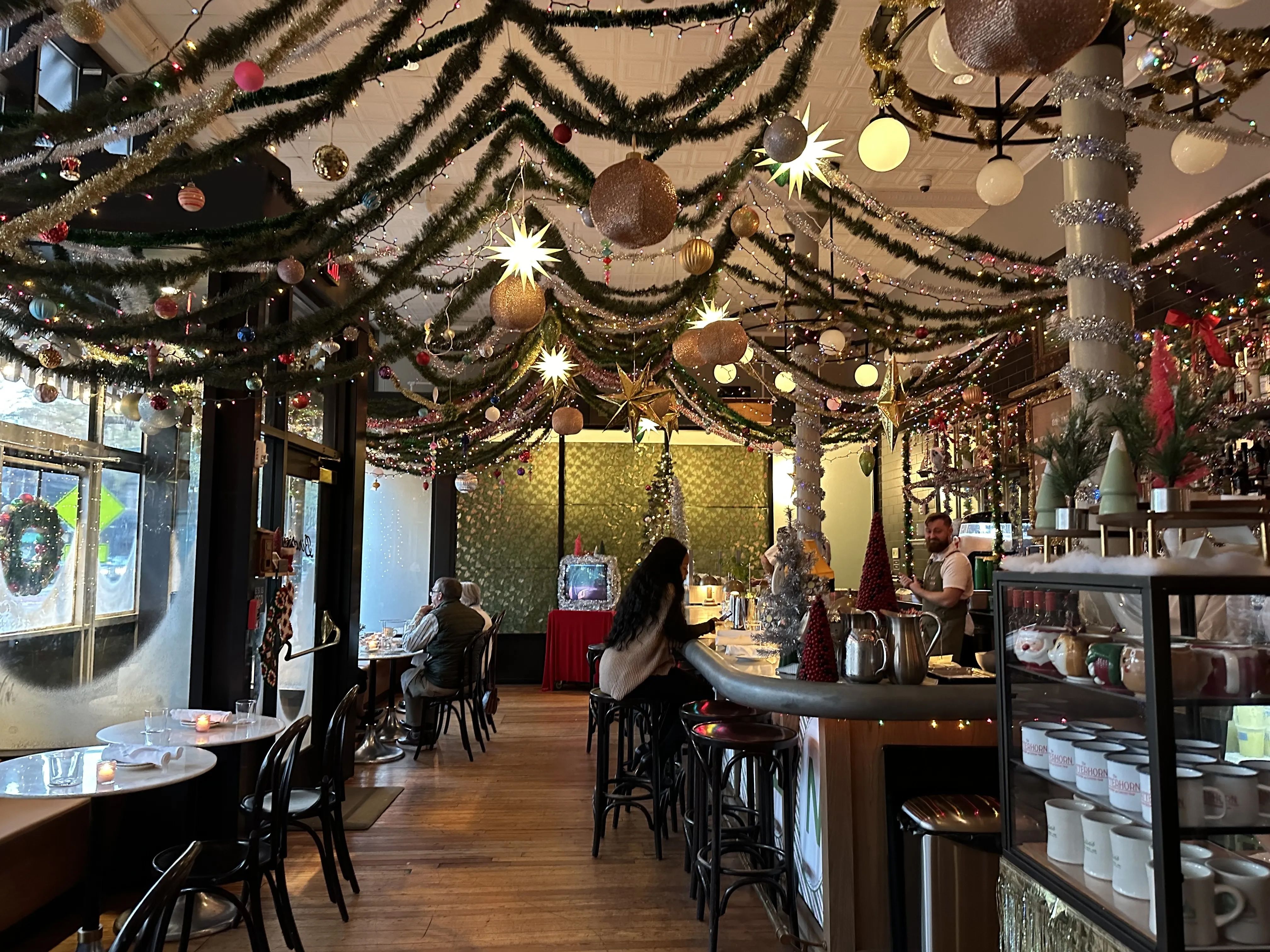 a restaurant covered in xmas garland 