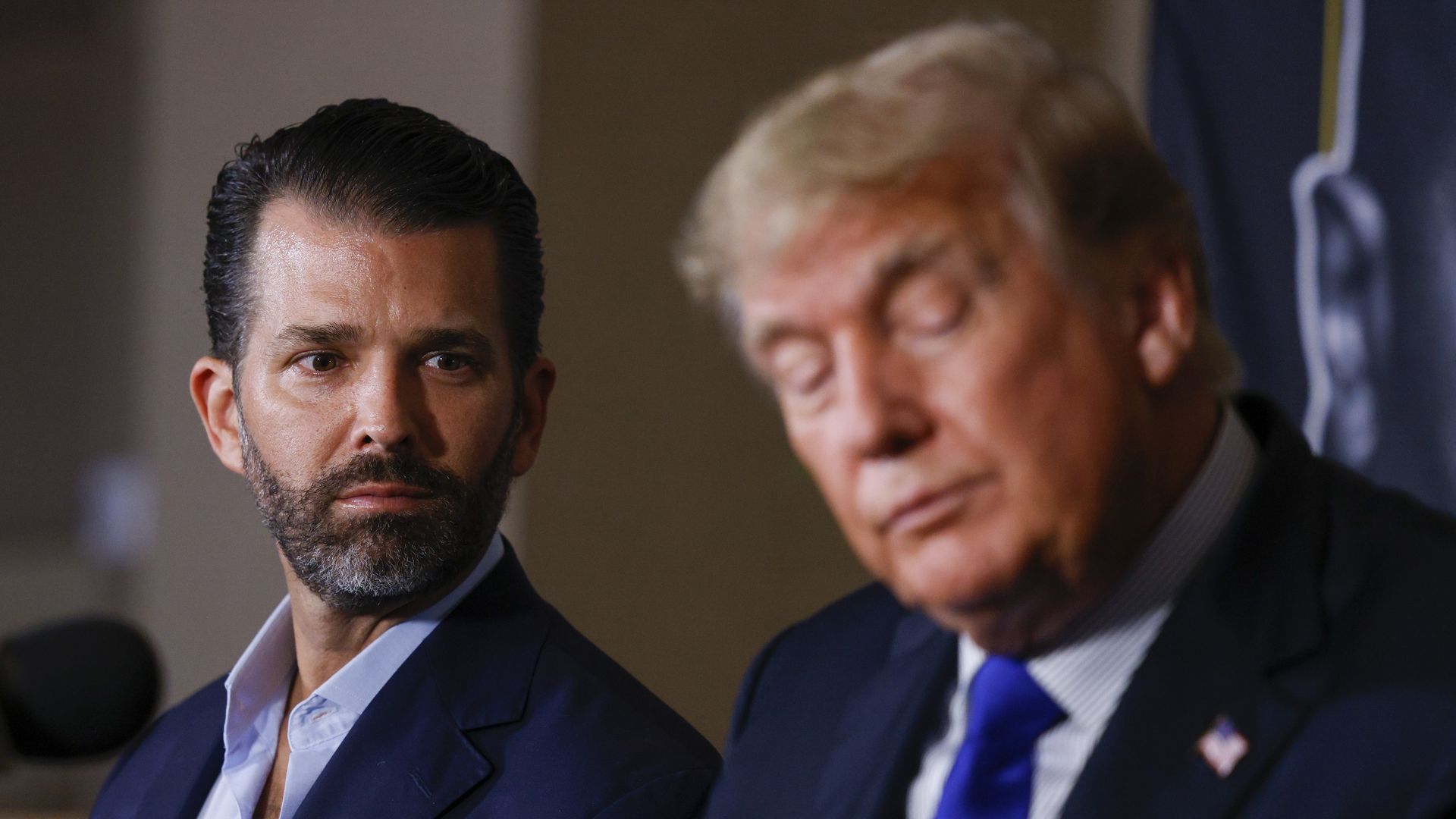 Photo of Donald Trump Jr looking to Donald Trump on his left