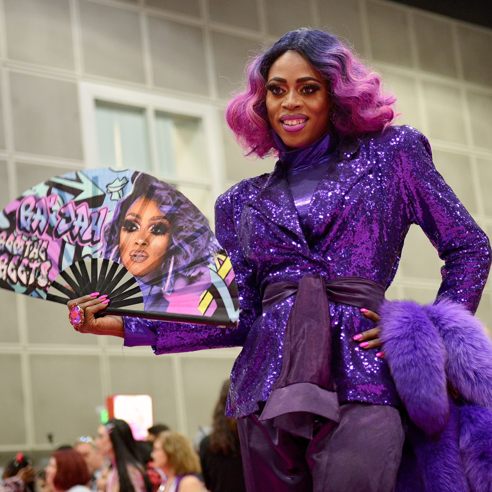 Ra'Jah O'Hara in a purple outfit with a fan reading "Ra'Jah from the streets"