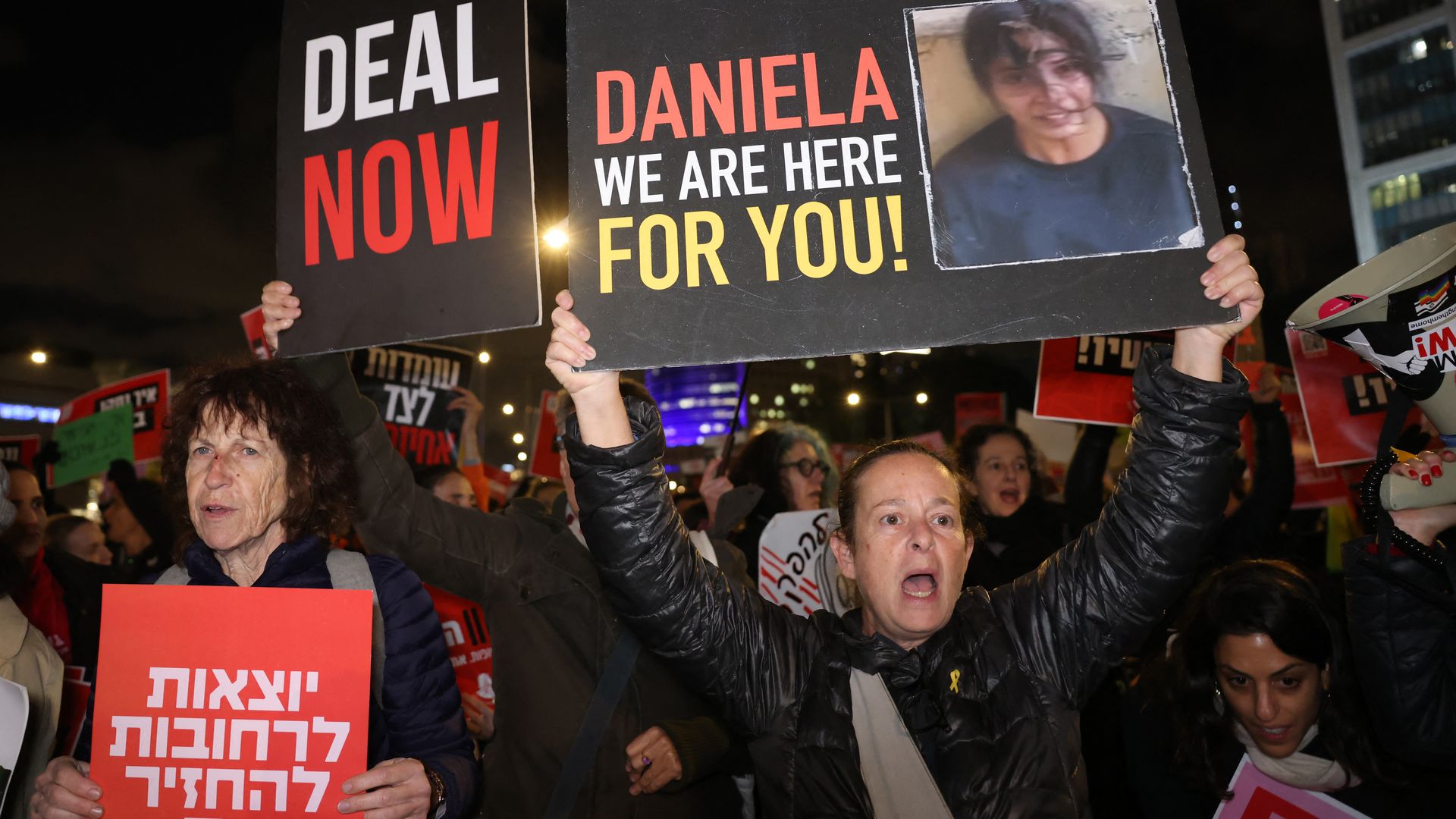 Israeli women raise placards bearing messages and the picture of Israeli hostages held by Hamas since October 7, 2023, as they protest outside the ministry of defence, callias, in Tel Aviv on February 1, ng for their release and negotiations for a deal between Israel and Ham2024. 