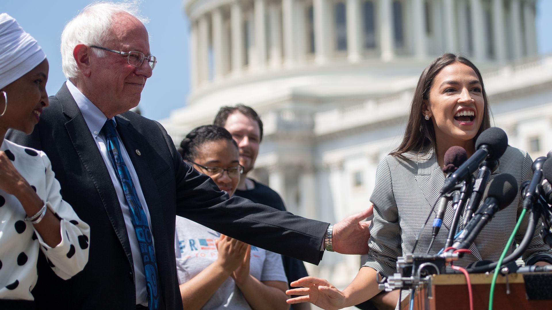Representative Alexandria Ocasio-Cortez (2nd R), Democrat of New York, speaks alongside US Senator Bernie Sanders