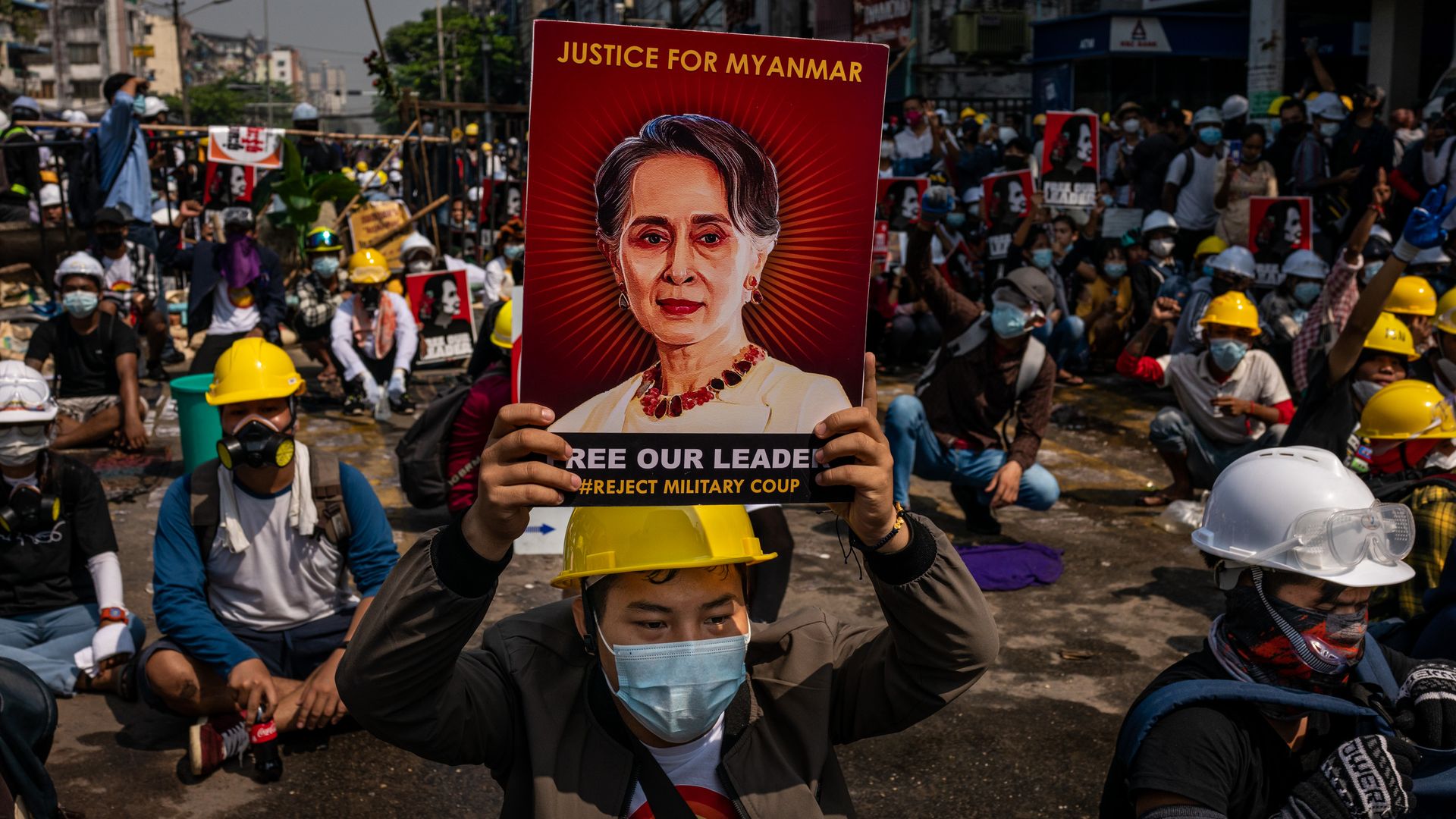 An anti-coup protester holds up a placard featuring de-facto leader Aung San Suu Kyi on March 02, 2021 in Yangon, Myanmar. 