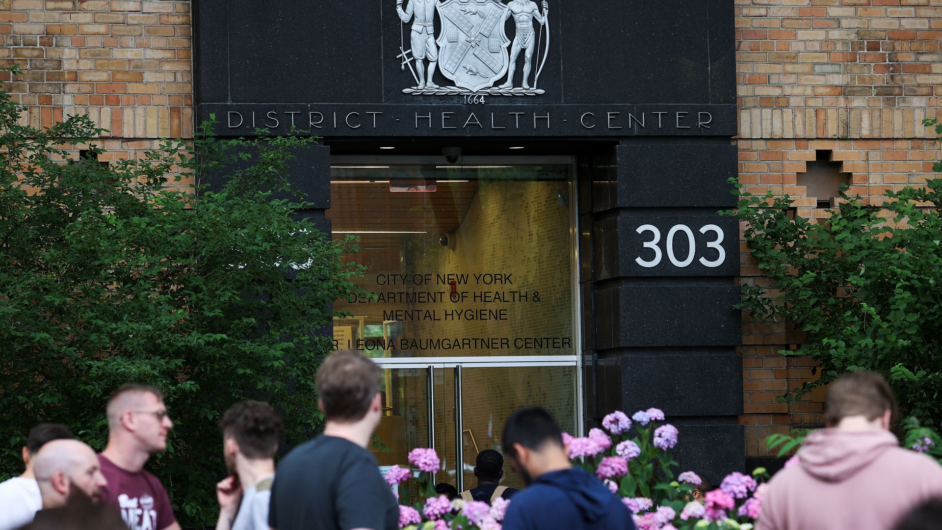 Photo of people lined up outside the New York City district health center