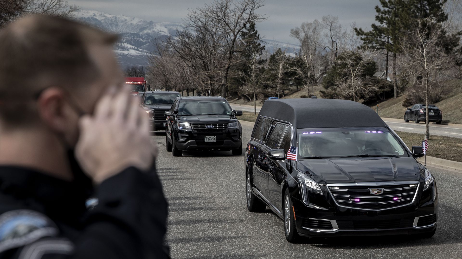 Law enforcement vehicles escort the body of slain Boulder Police Officer Eric Talley to Arvada, Colorado on Wednesday, March 24, 2021.