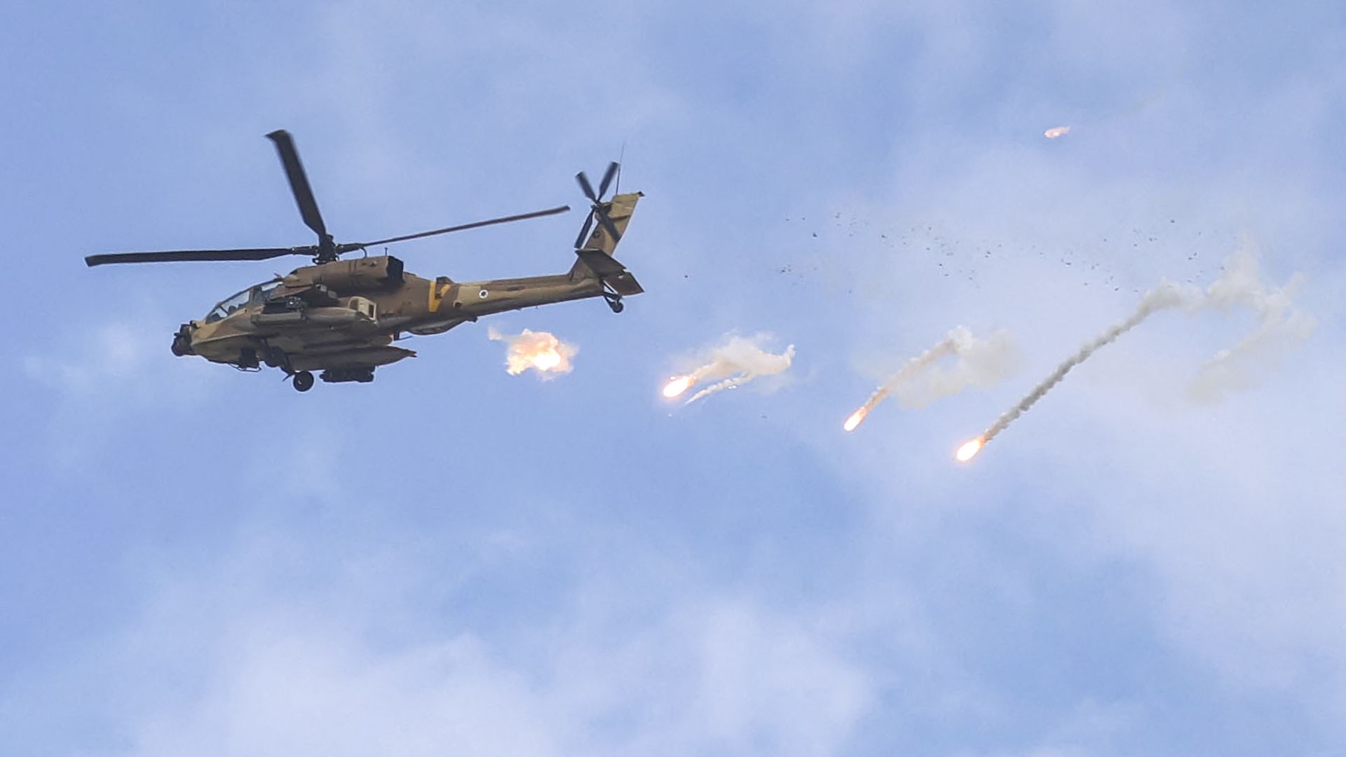 An Israeli Air Force AH-64 Apache attack helicopter releases flares during an Israeli army raid in Jenin in the occupied West Bank on June 19, 2023. Violent clashes erupted in Jenin on June 19 during an Israeli raid on the West B
