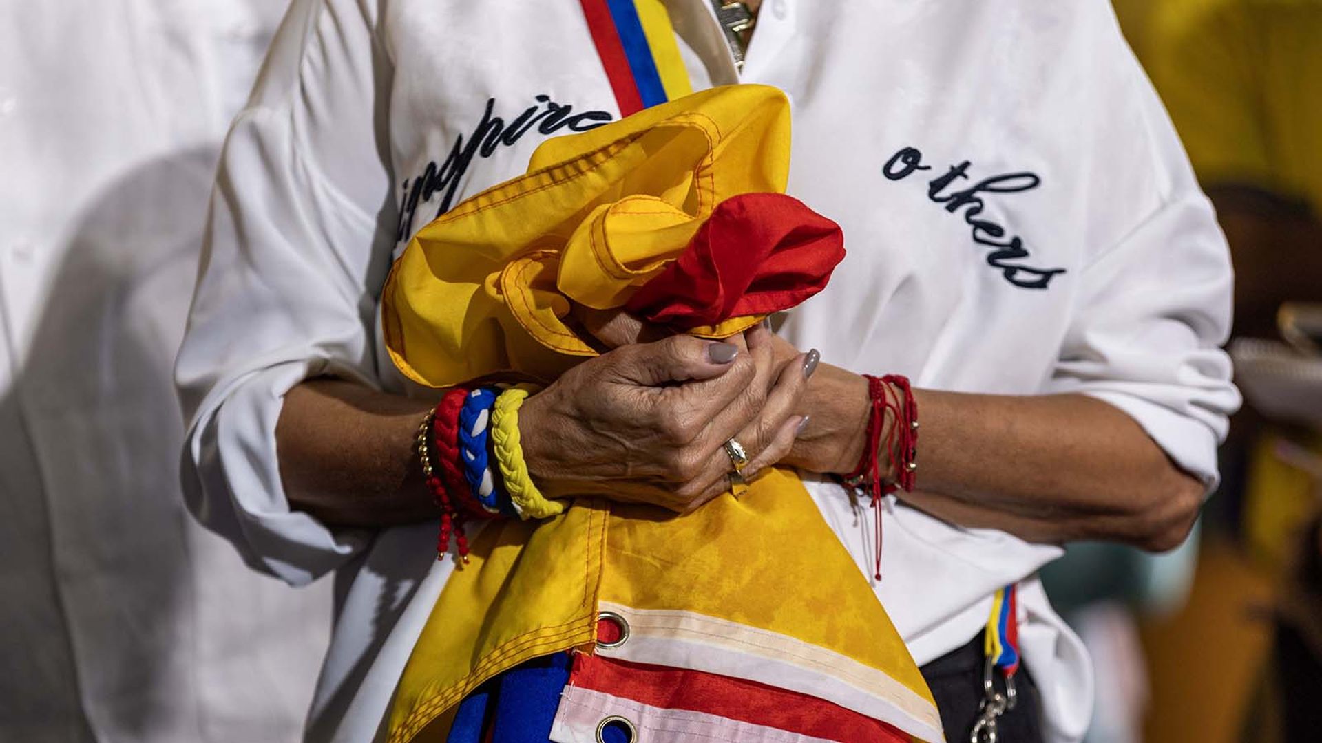 A woman holds a Venezuelan flag during a press conference held by Venezuelan American Caucus and hosted at El Arepazo on Monday, Feb. 3, 2025, in Doral, Florida. (D.A. Varela/Miami Herald/Tribune News Service via Getty Images)
