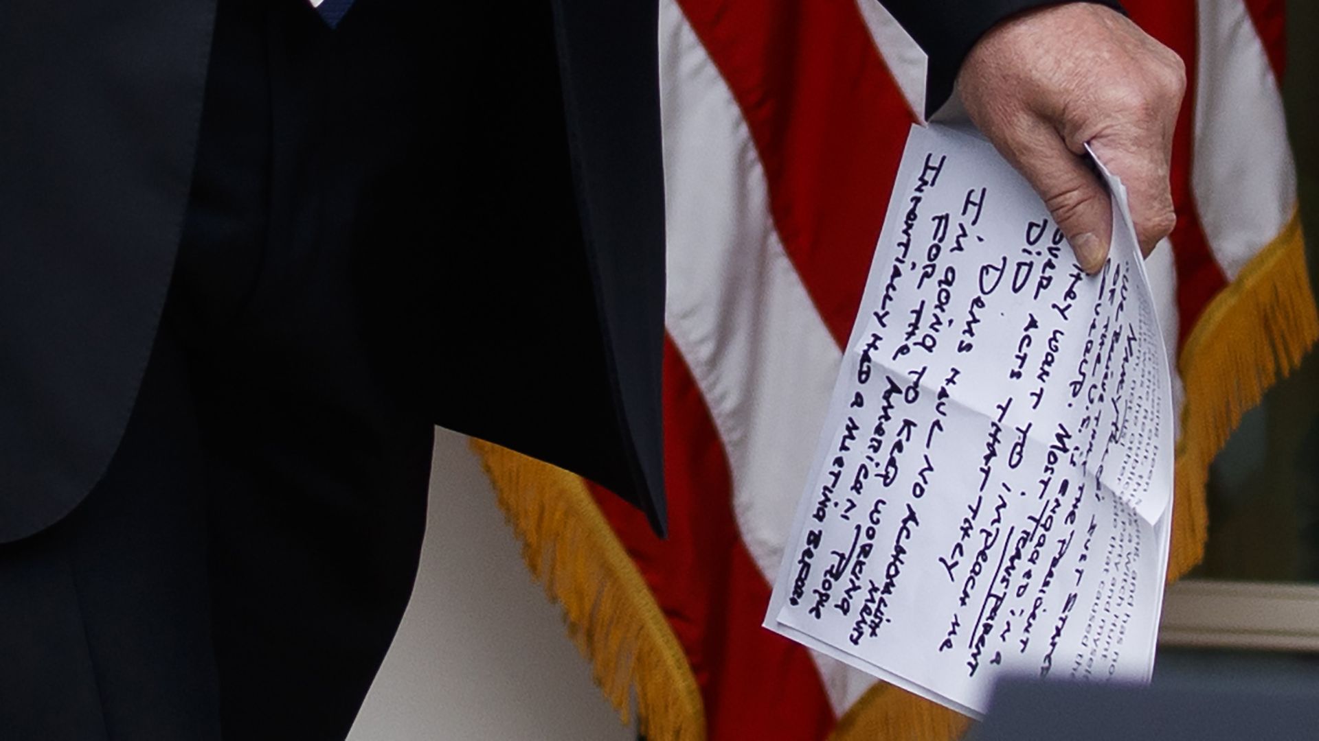 President Trump carries notes that say "they want to impeach me" as he walks from the Oval Office to speak in the Rose Garden on Wednesday