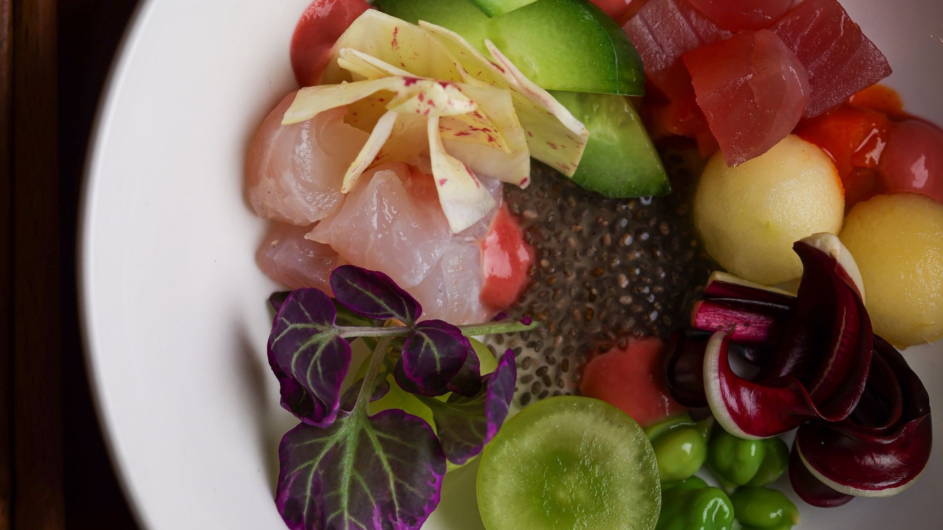 A prosperity salad with various colorful fish and vegetables.