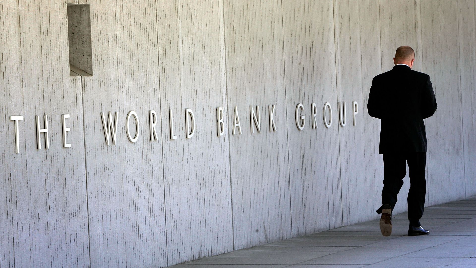 An employee walks outside the World Bank headquarters May 8, 2007 in Washington, DC. 