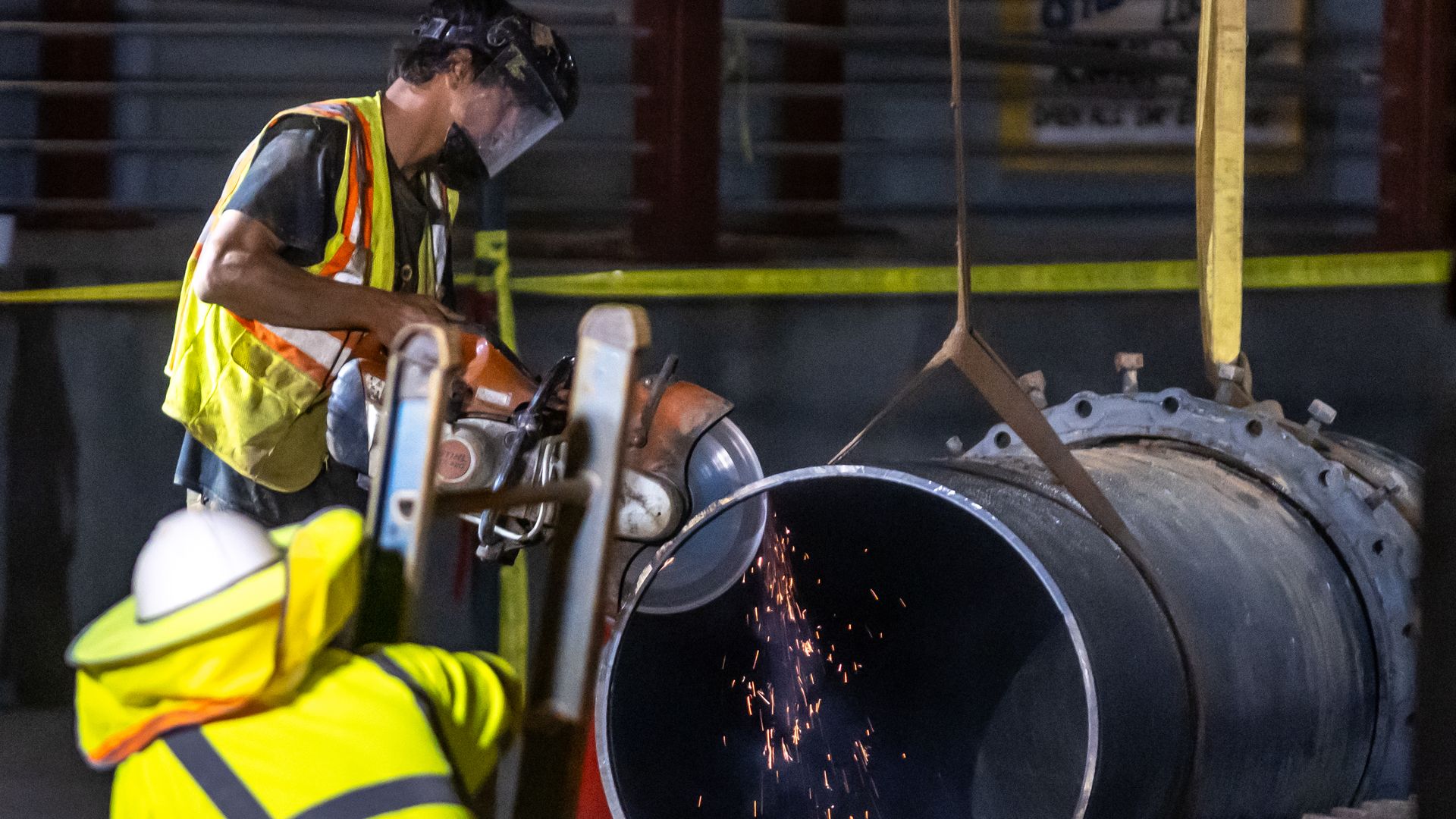 Crews saw part of a pipe used to repair a water main break on 11th and W. Peachtree streets in Midtown Atlanta.