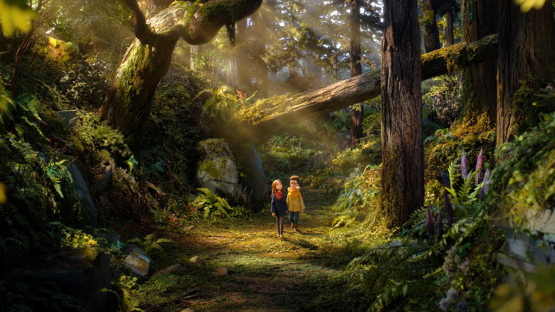 Sunlit forest path with a large fallen tree trunk across; two children in jackets walk together, one in yellow and one in blue, surrounded by ferns, moss, and lush foliage.
