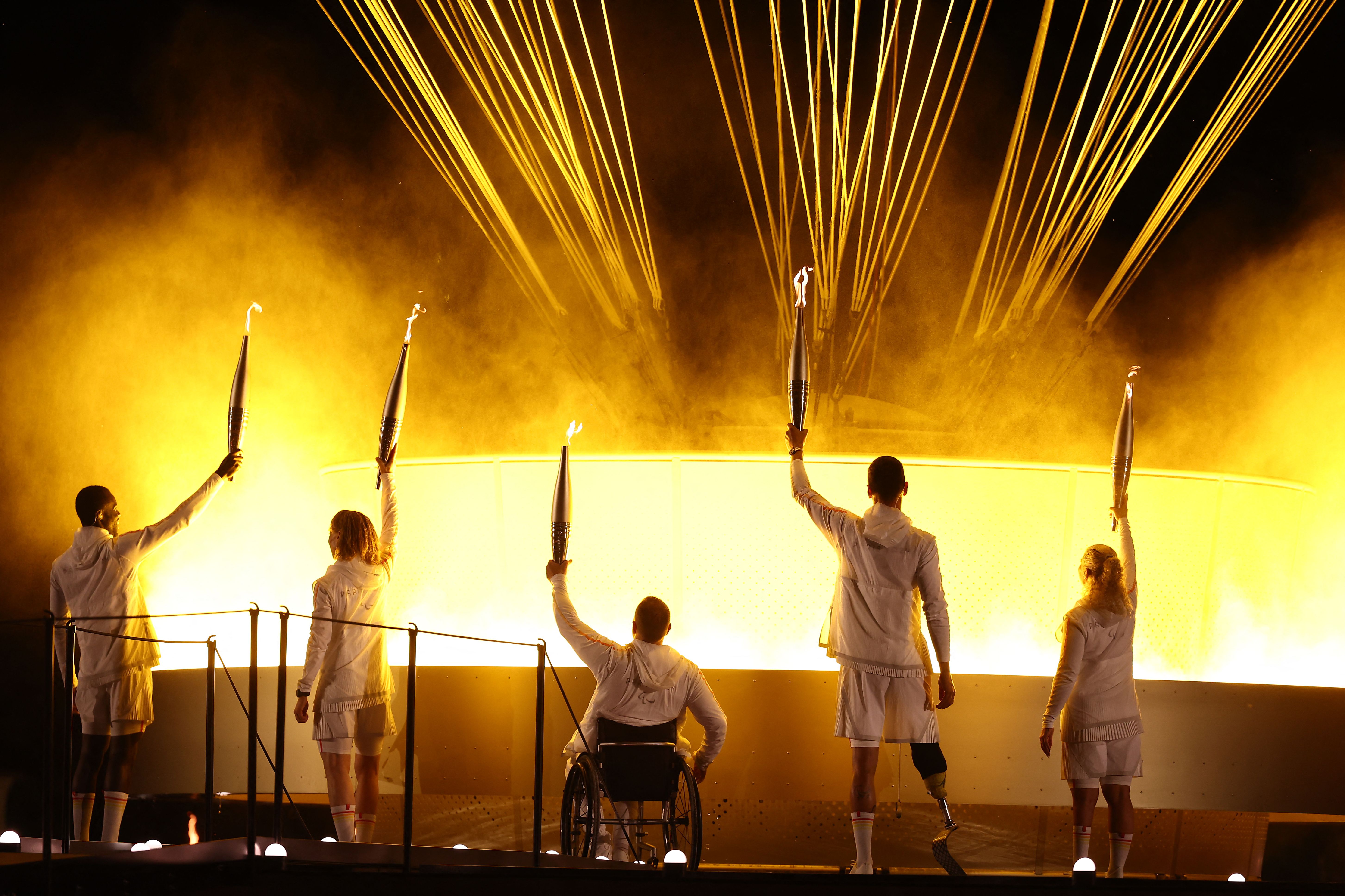 - LtoR, France's paralympic torchbearers, Charles-Antoine Kaoukou, Nantenin Keita, Fabien Lamirault, Alexis Hanquinquant and Elodie Lorandi hold the Paralympic flame in front of the Paralympic cauldron during the Paris 2024 Paralympic Games Opening Ceremony at the Jardin des Tuileries .