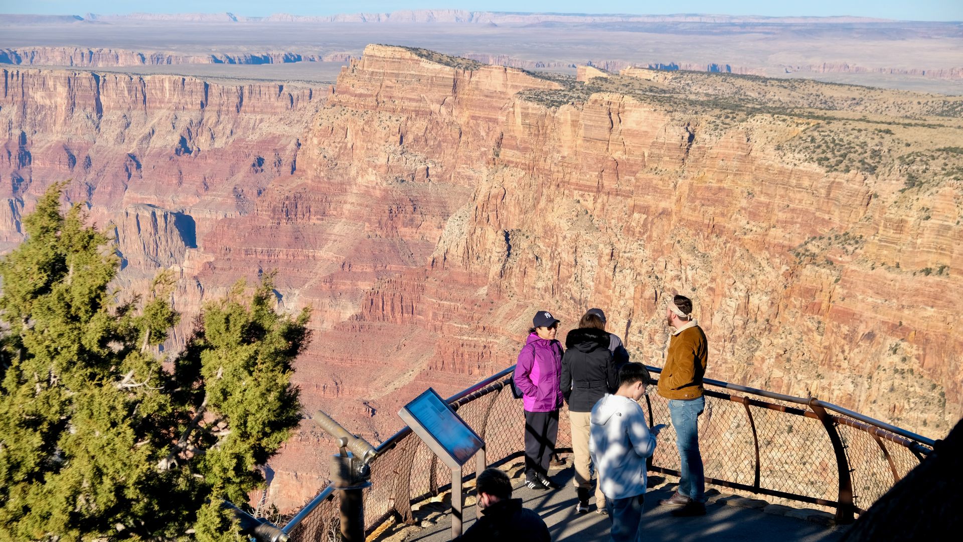 People look over the Grand Canyon.