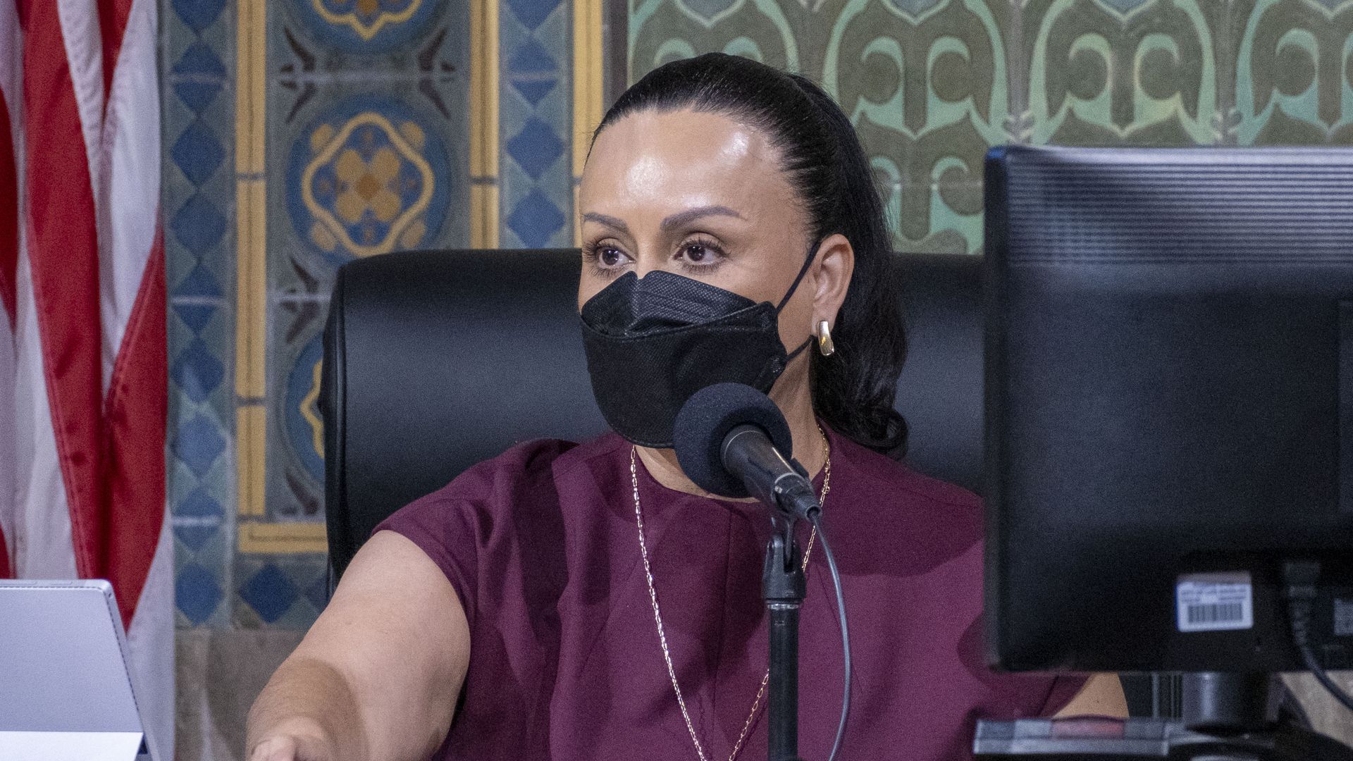 Photo of a masked Nury Martinez sitting at a desk