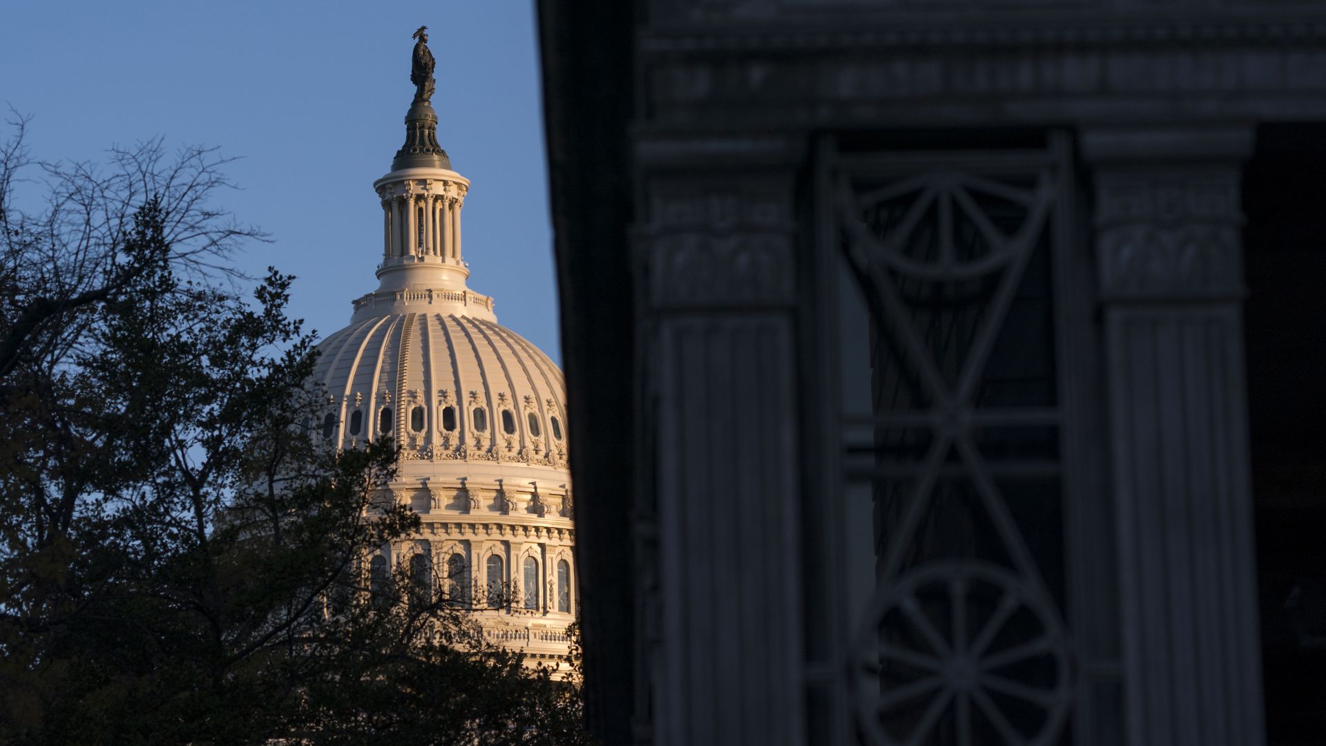 The Capitol building, partially eclipsed by shadow.