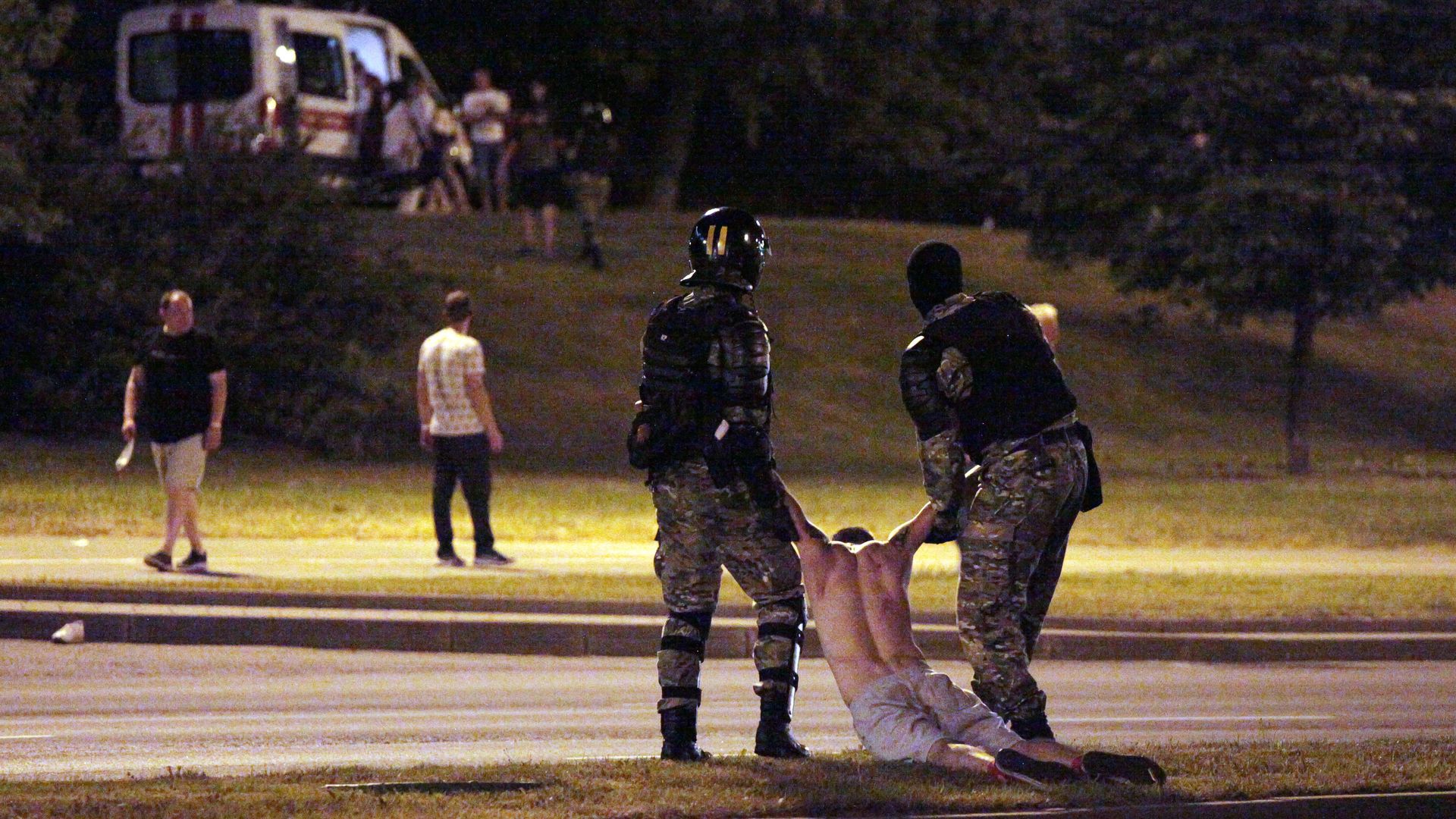 Riot police detain a protester after polls closed in the presidential election, in Minsk on August 9