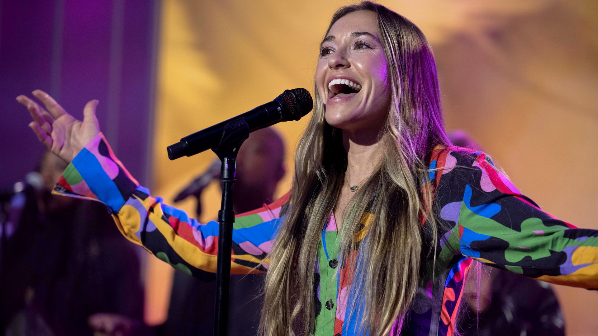 Lauren Daigle singing on stage. 