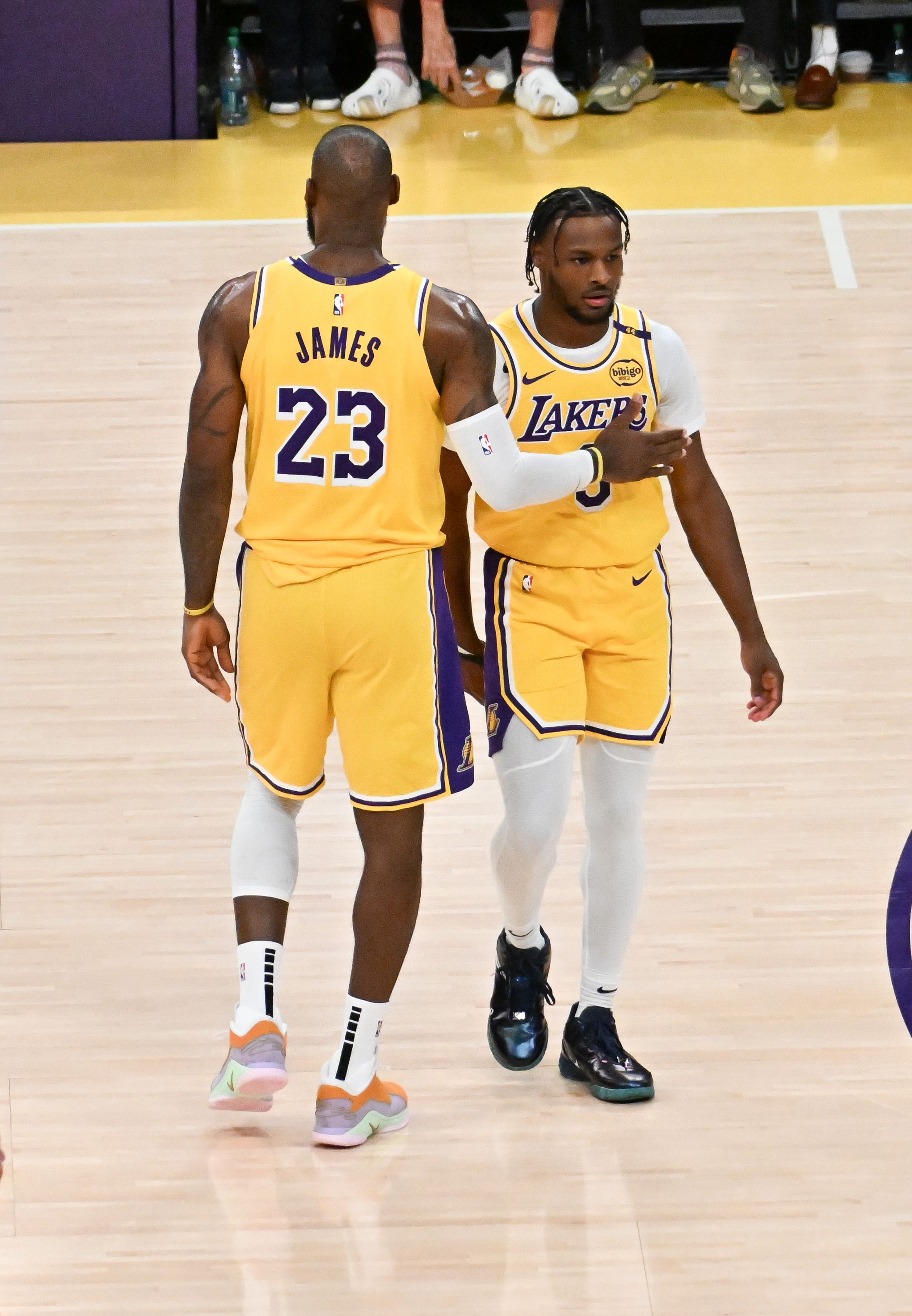  LeBron James #23 and Bronny James #9 of the Los Angeles Lakers on the court for the first time during the game against the Minnesota Timberwolves at Crypto.com Arena on October 22, 2024 in Los Angeles, California. 