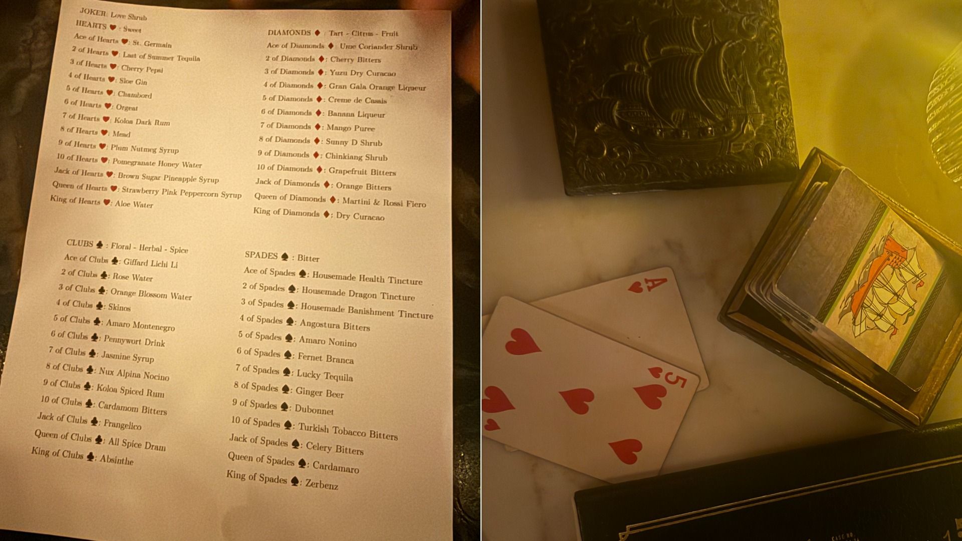 A drinks menu with ingredients listed under card suits Hearts, Diamonds, Clubs, and Spades, next to two playing cards (Ace and 5 of Hearts) and an open box of cards on a marble surface.