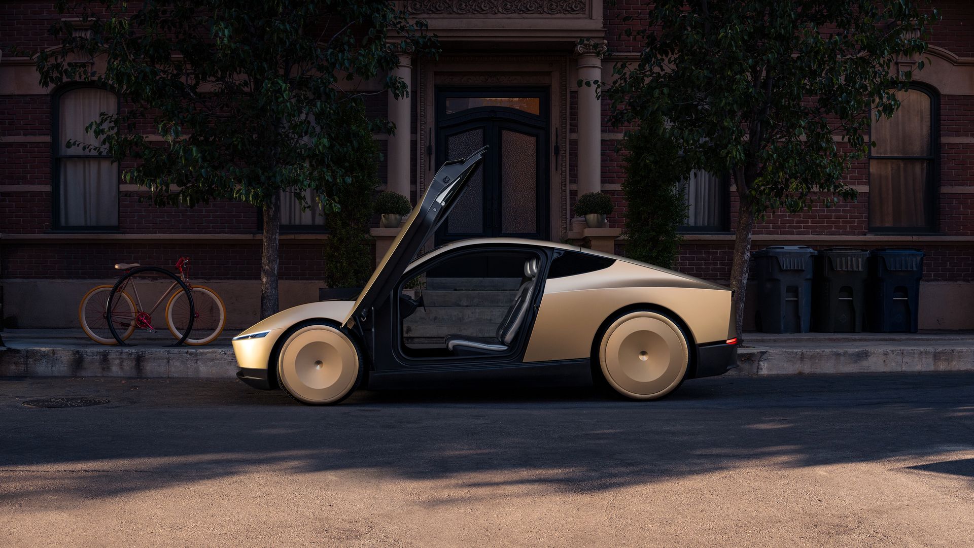 A gold-toned futuristic car with gull-wing doors open on a city street in front of a brick building; a yellow bicycle rests by a tree, with dark trash bins along the curb.