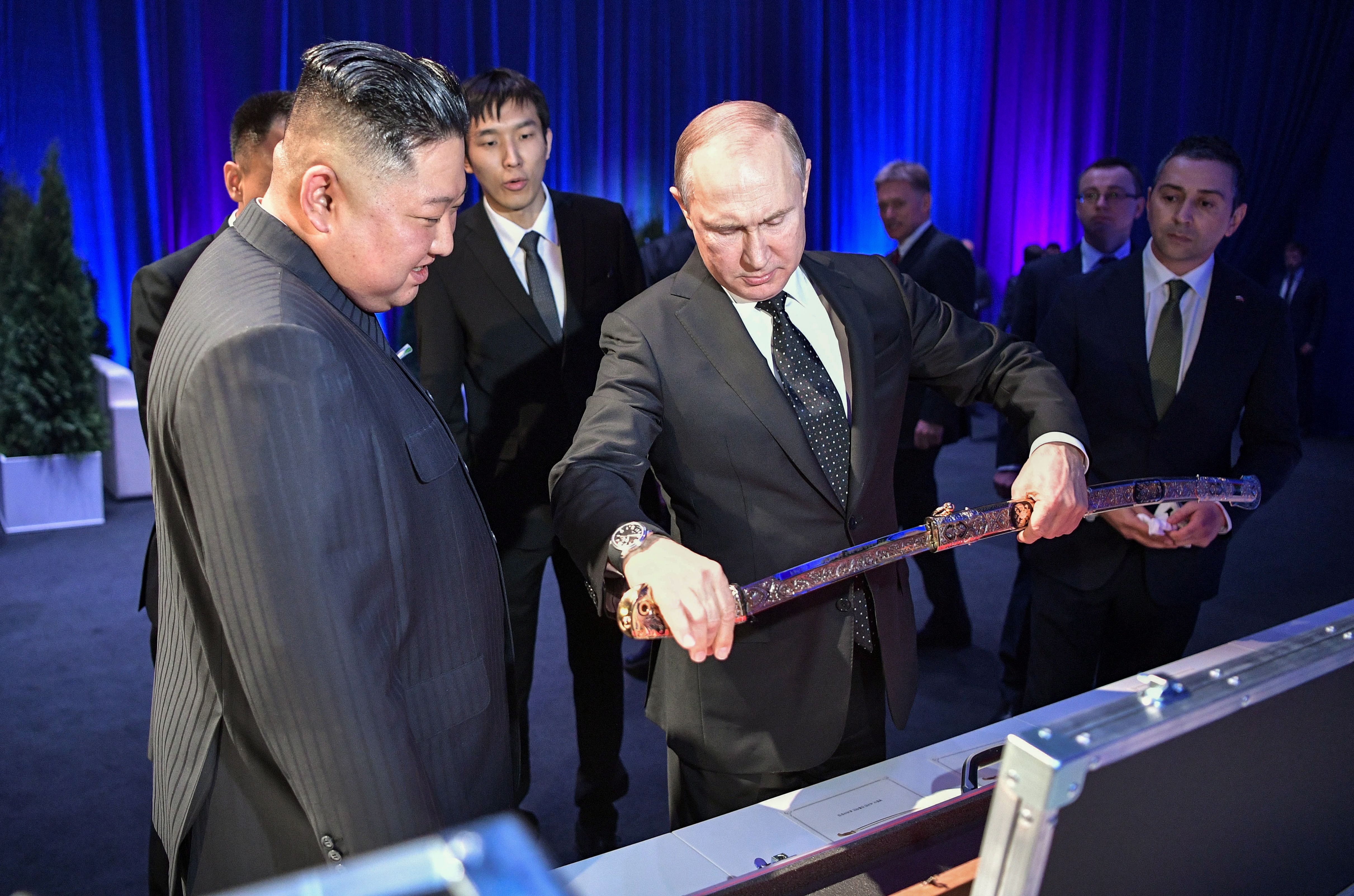 Kim presents a sword to Putin. 