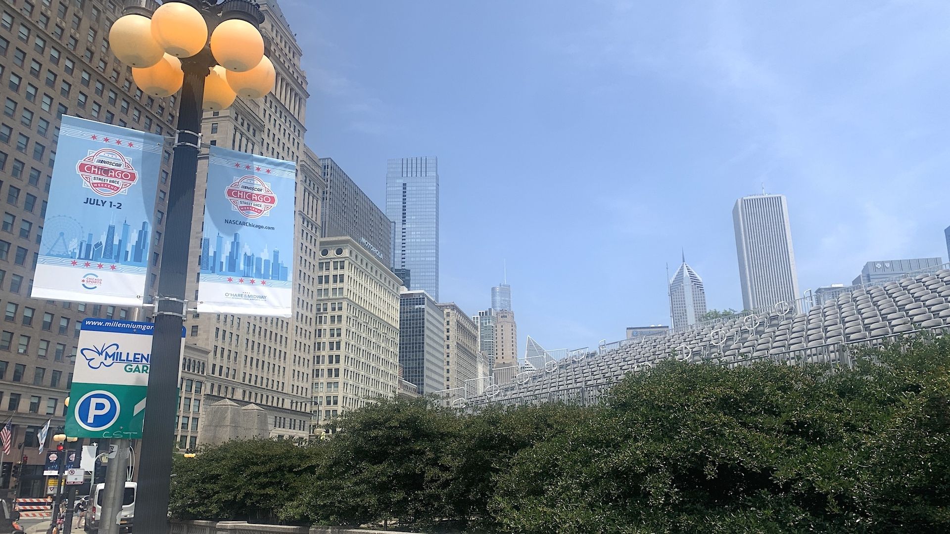 Photo of seats being put in for a street race with skyscrapers in back 