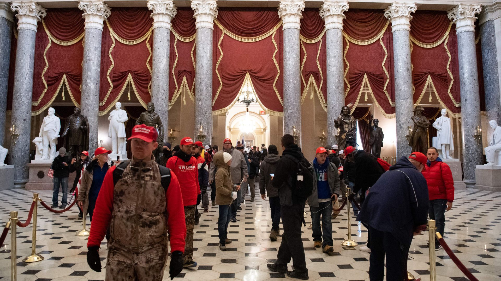 Insurrectionists are seen in Statuary Hall on Jan. 6, 2021.