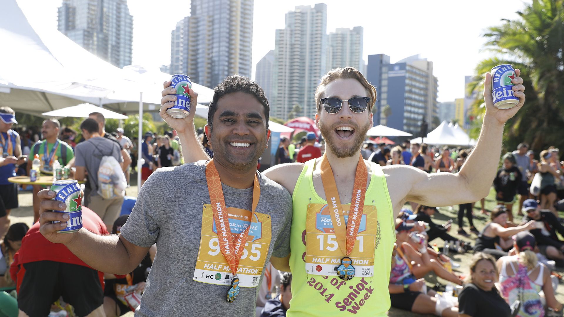 Two runners celebrate with beers after a half marathon.