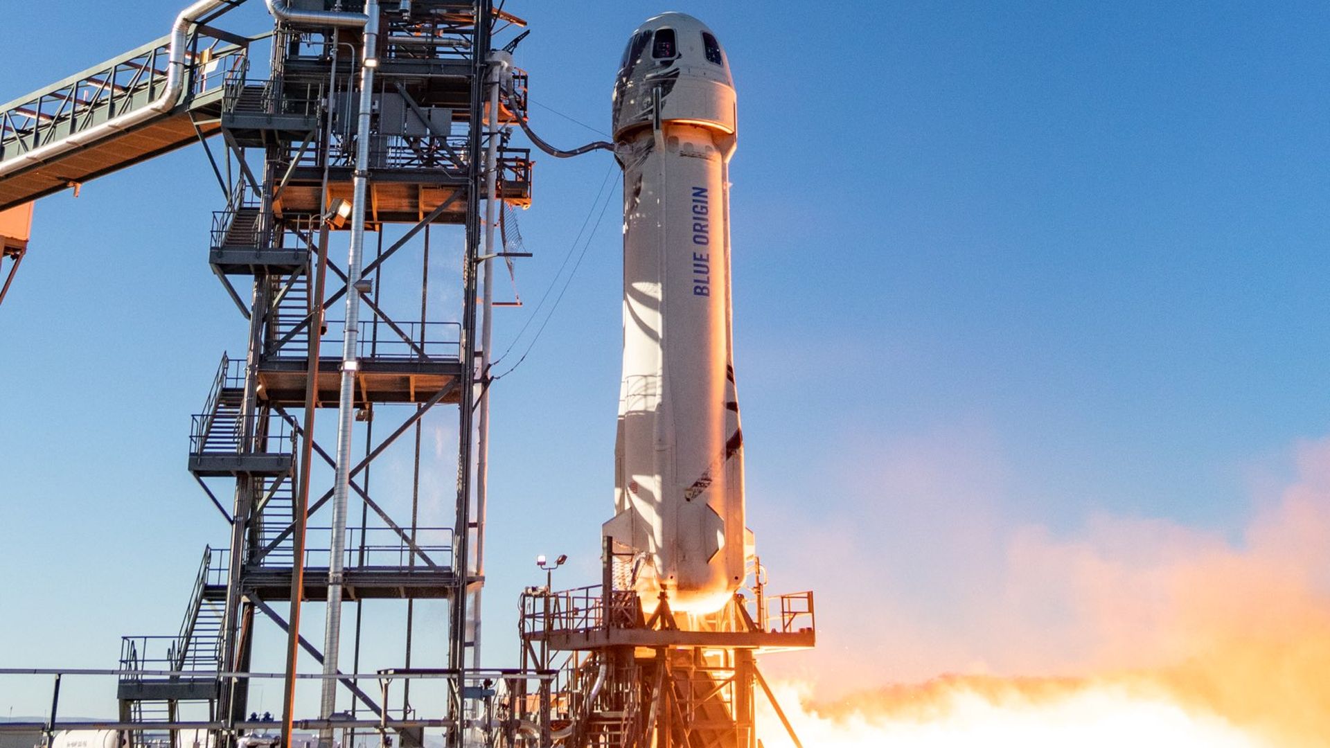 A rocket with engine started about to lift off from the pad