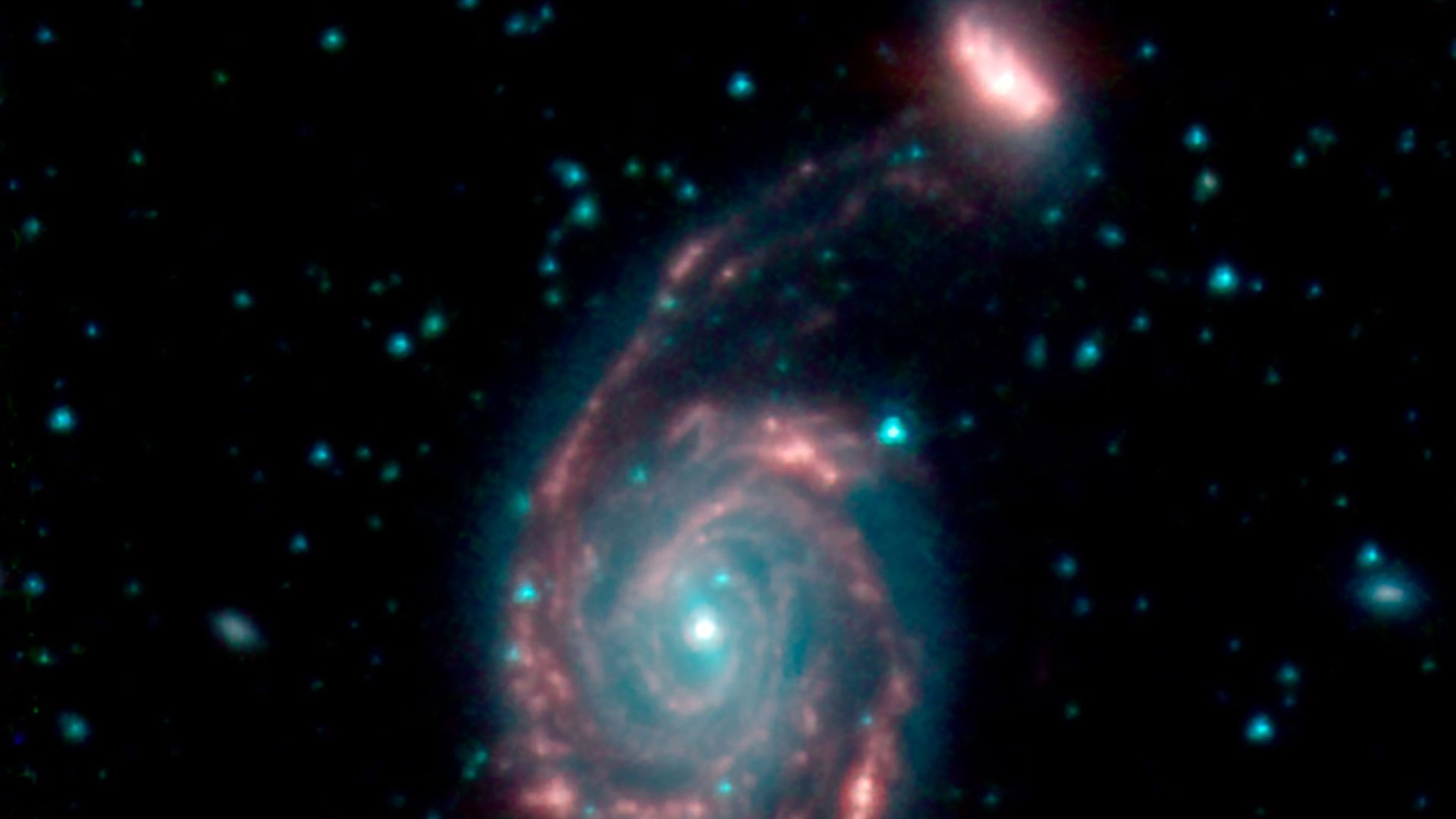 Two galaxies merging in deep space.