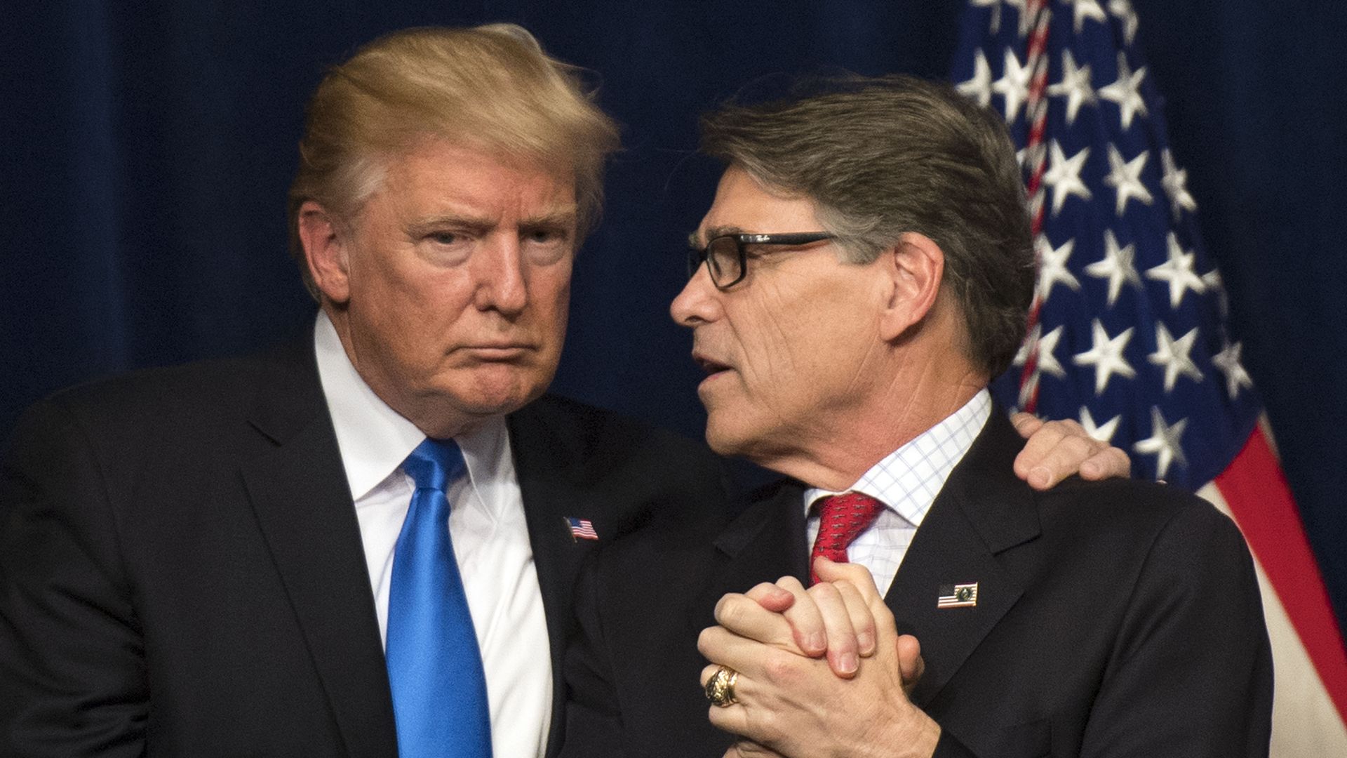 U.S. President Donald Trump (L) embraces Energy Secretary Rick Perry after Trump delivered remarks