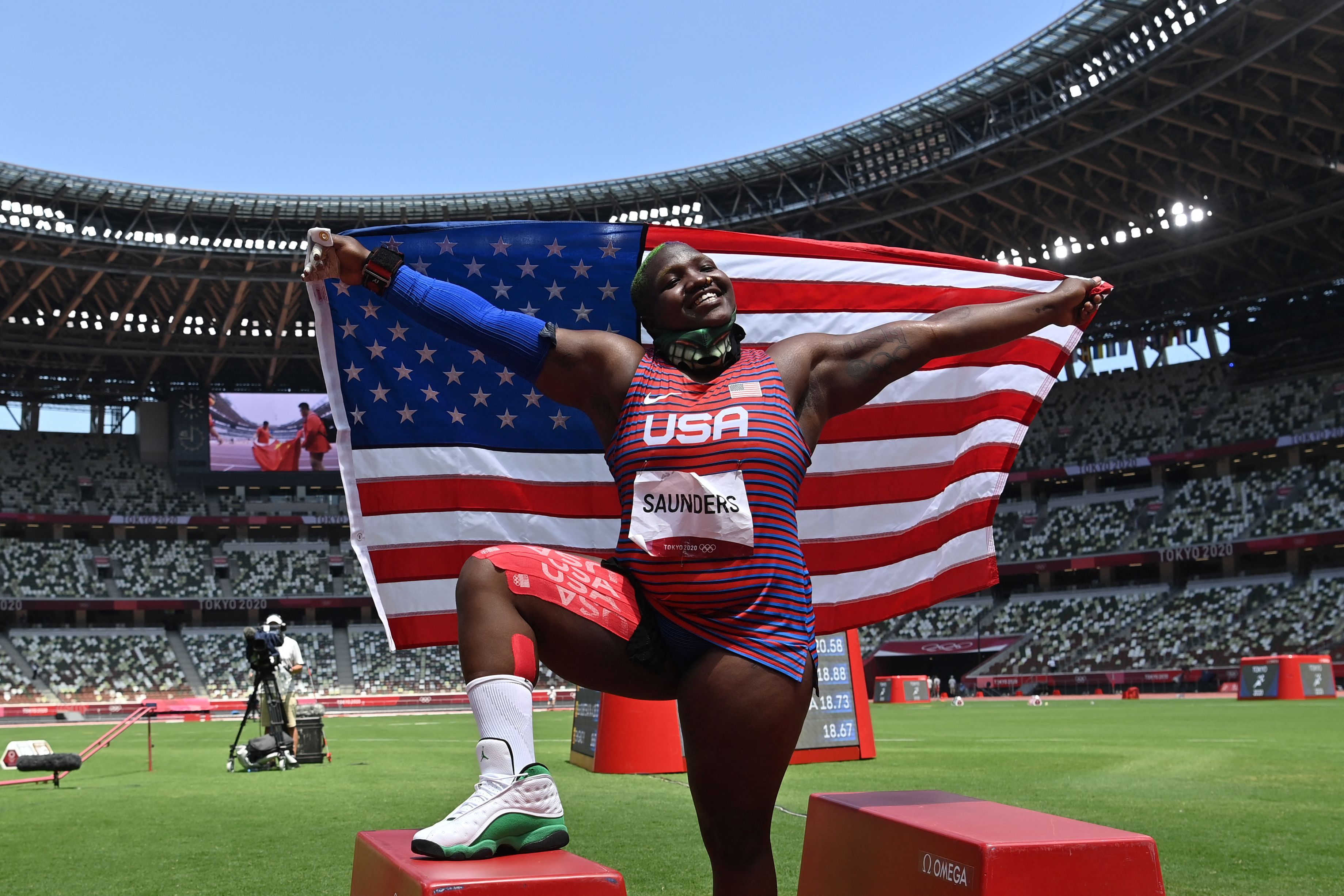  USA's Raven Saunders celebrates with her national flag after placing second in the women's shot put final during the Tokyo 2020 Olympic Games at the Olympic Stadium in Tokyo on August 1