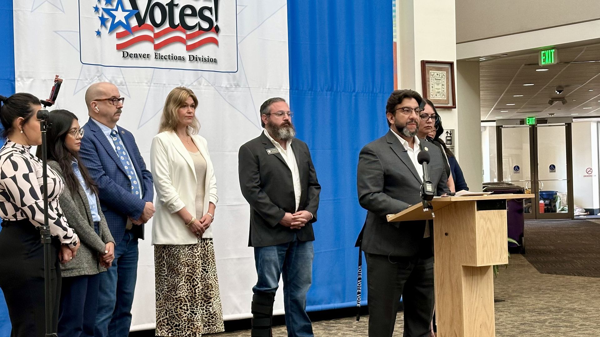 Clerk Paul Lopez, front right, talks about budget cuts at his Denver office Sept. 16, 2025. Photo: John Frank/Axios