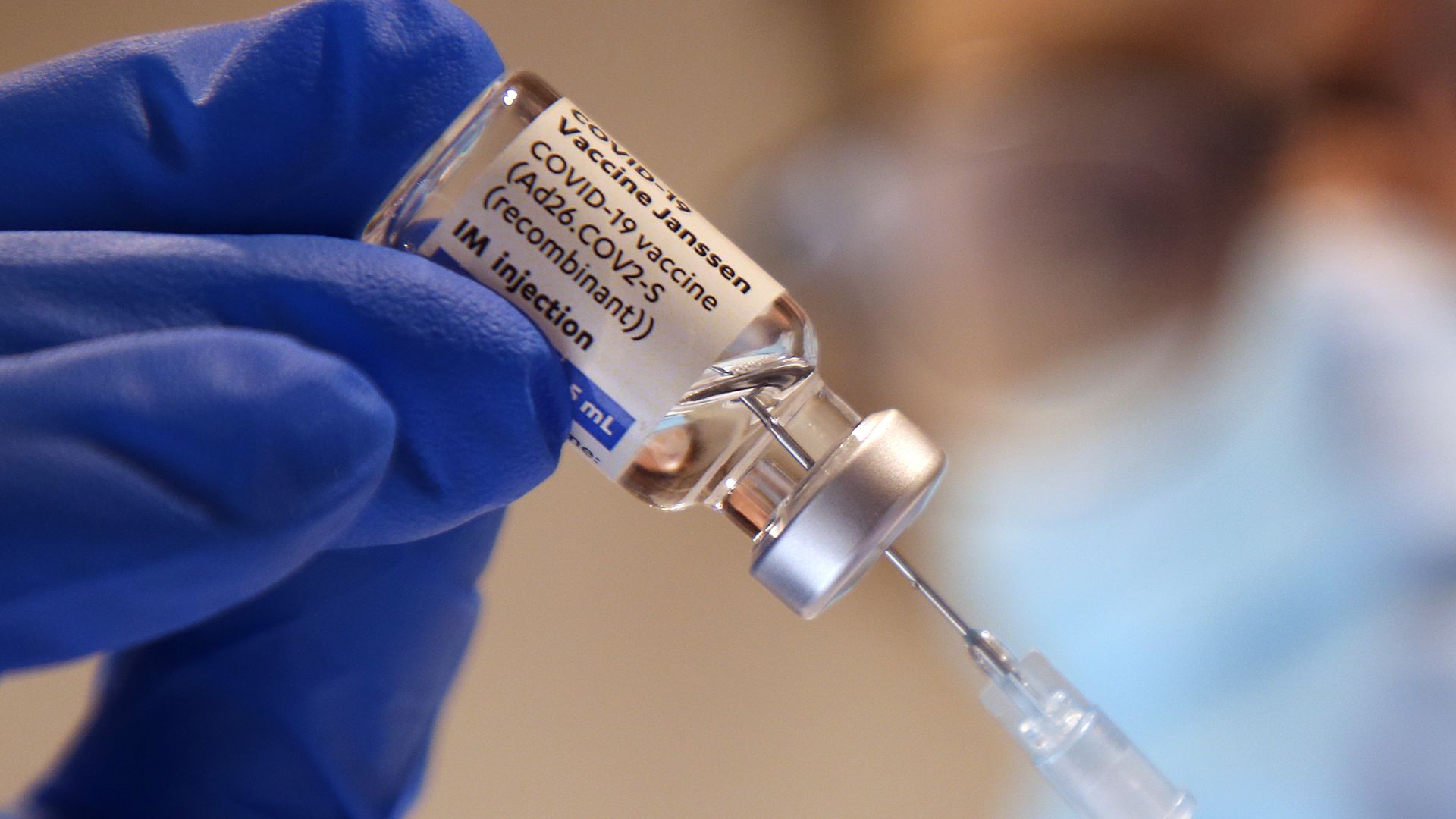A physician's assistant draws up a shot of Johnson & Johnson's Janssen coronavirus vaccine in a primary care physician's office.