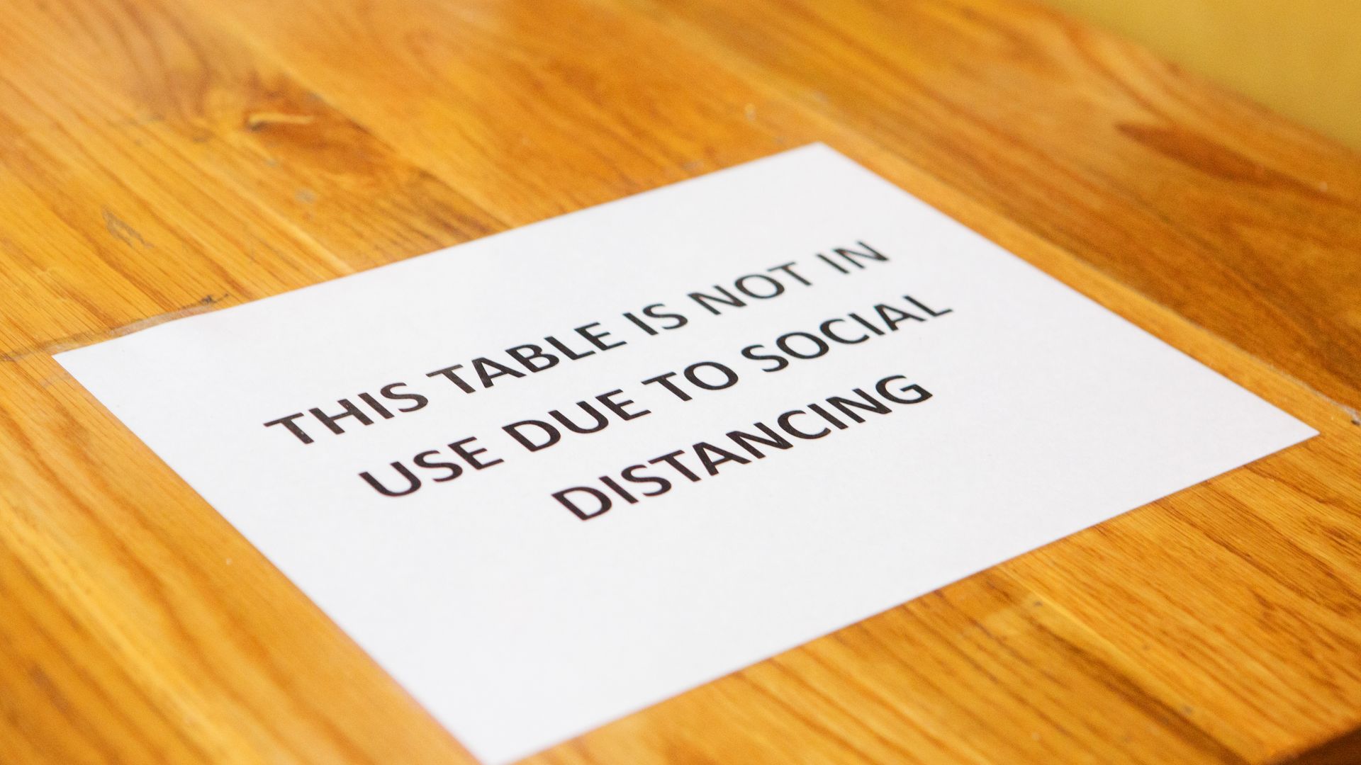 A sign declares a table off limits for social distancing at an Austin restaurant.
