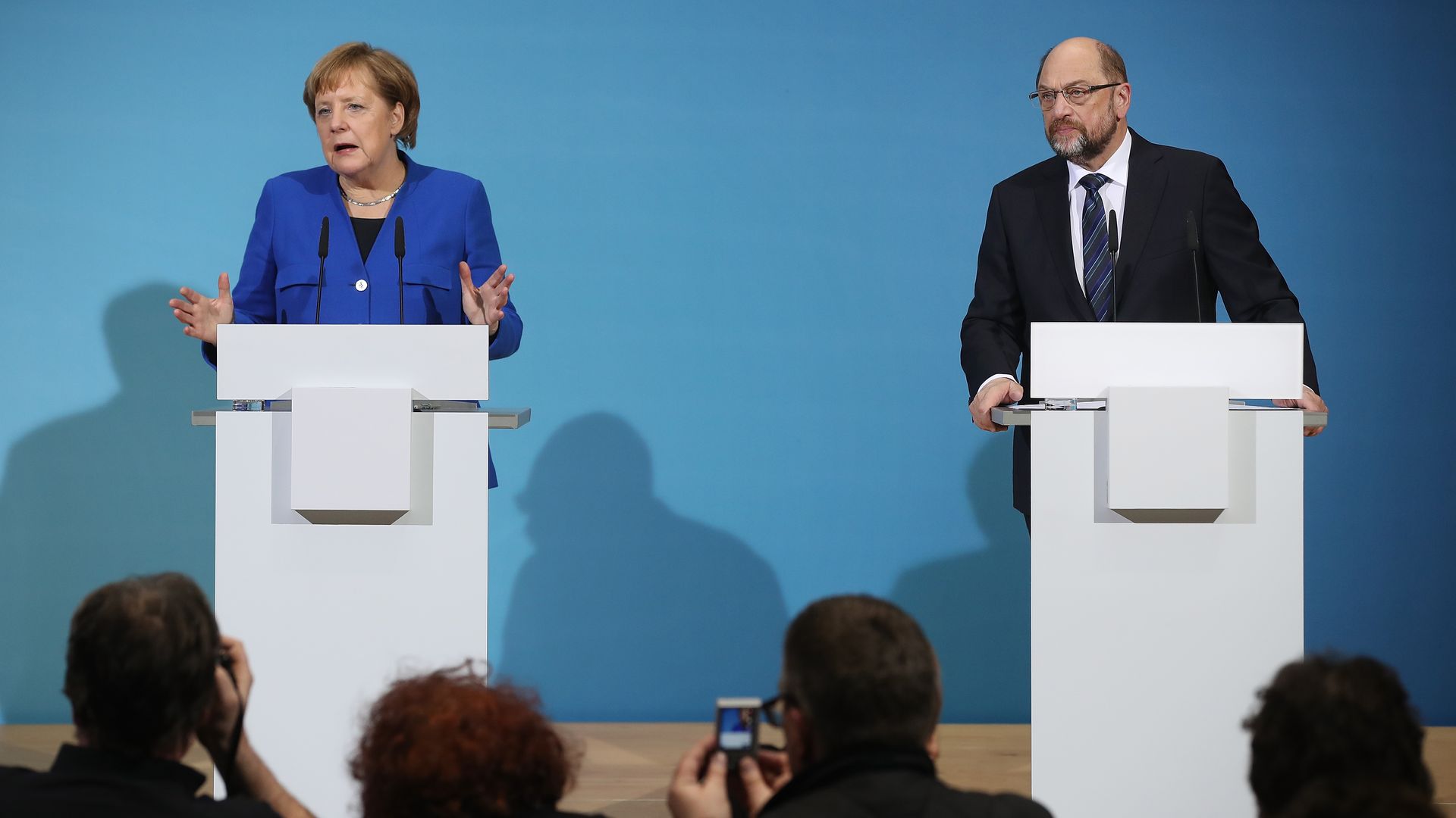 Angela Merkel and Martin Schultz speak at podiums