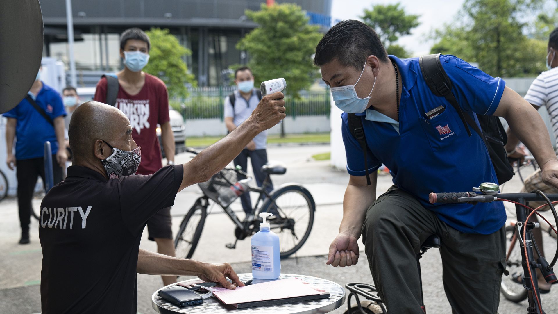 Factory workers being tested before entering a dormitory in Singapore