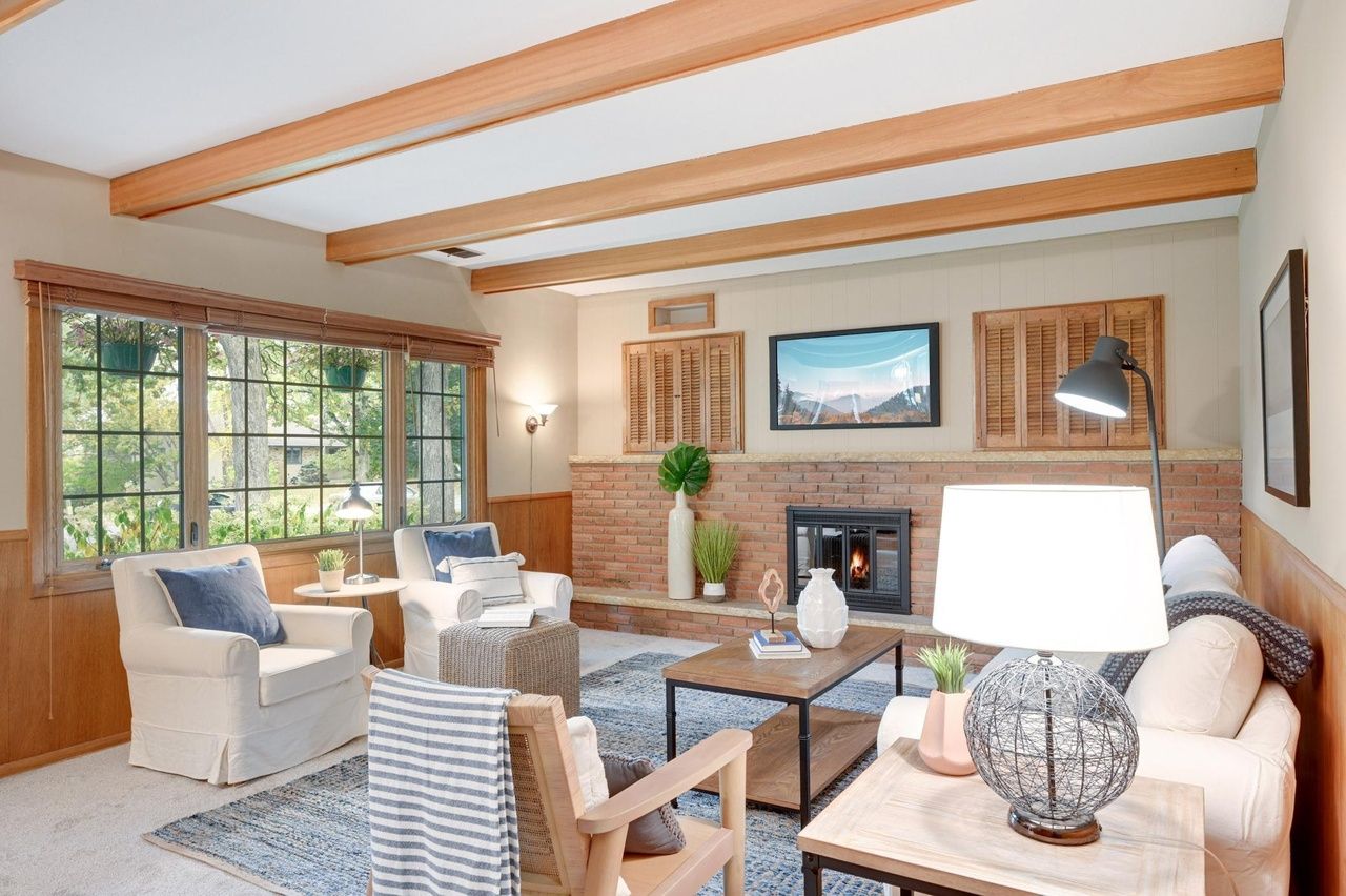 living room with fireplace and wood ceiling beams