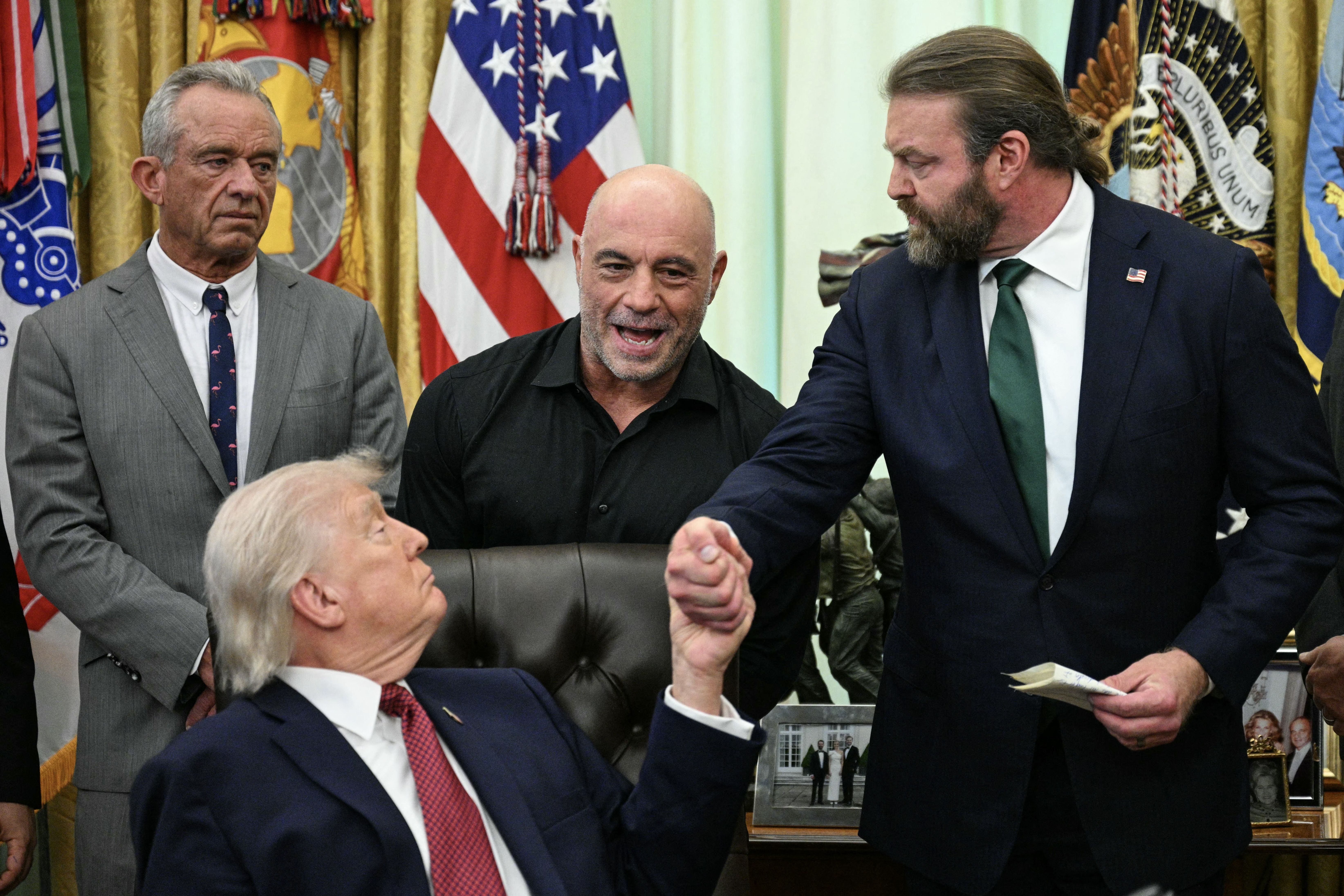 Joe Rogan joined President Trump in the Oval Office on Saturday, flanked by Health and Human Services Secretary Robert F. Kennedy Jr. and Americans for Ibogaine CEO W. Bryan Hubbard. 