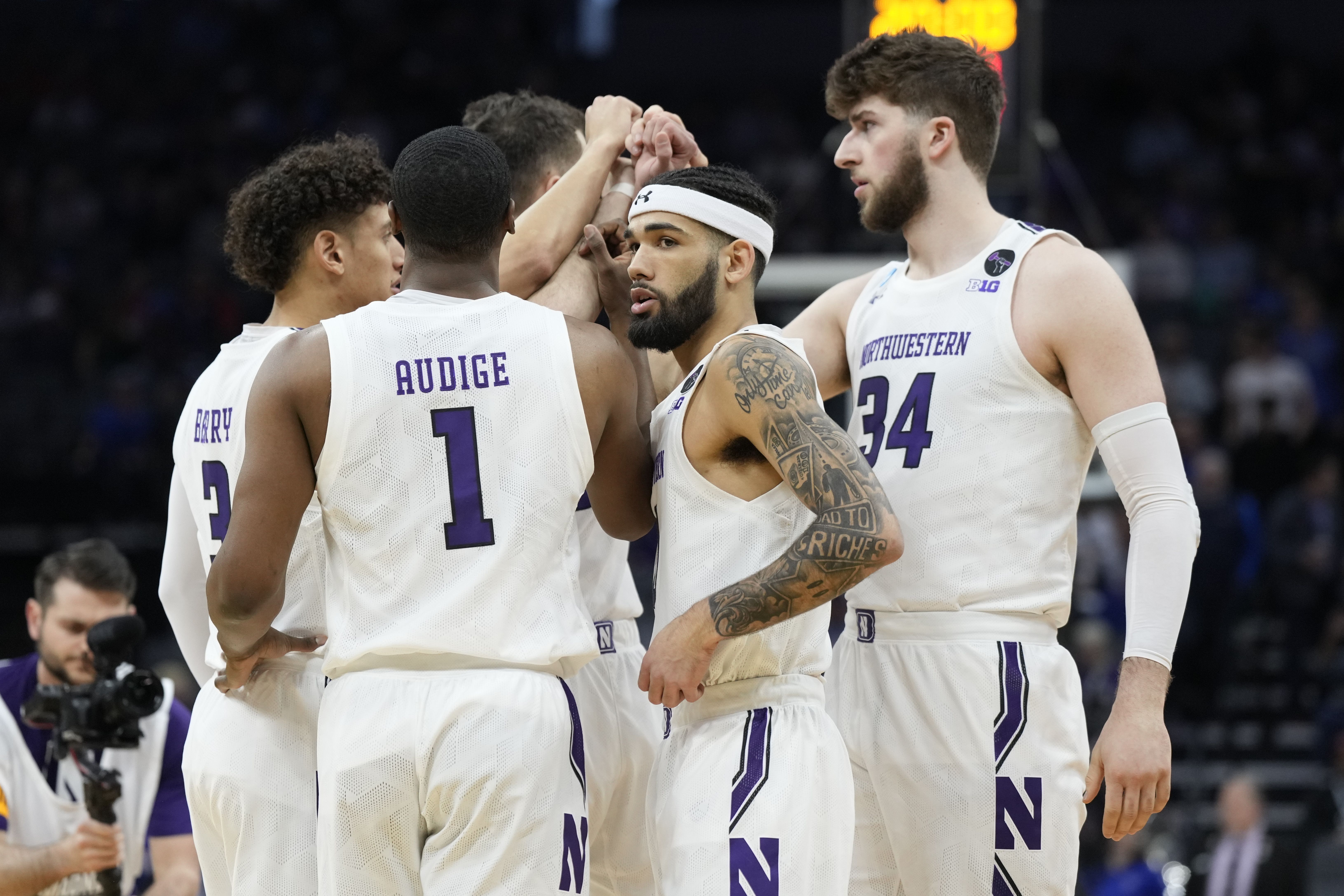 Photo of a team huddling on a basketball court